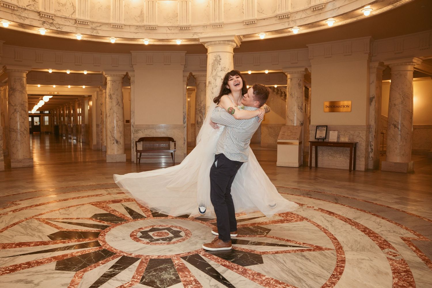 A grand domed interior space with ornate architectural details and warm lighting.