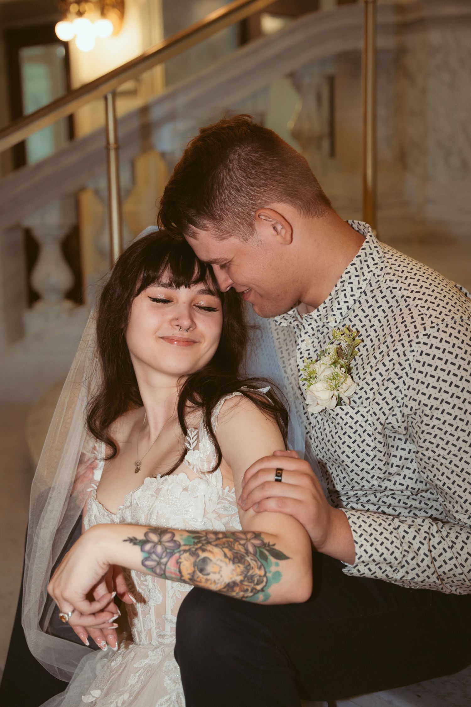 Intimate wedding portrait captured indoors with soft lighting and romantic poses.