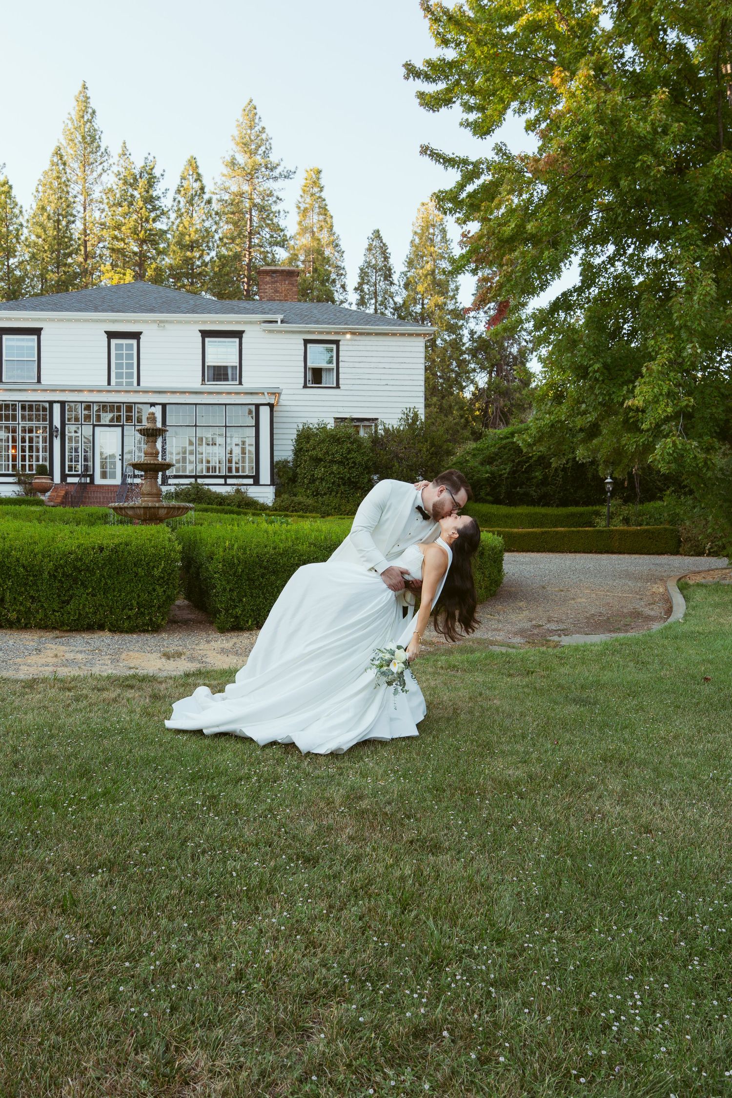 Romantic wedding sequence showing couple in an outdoor garden setting with house in background.