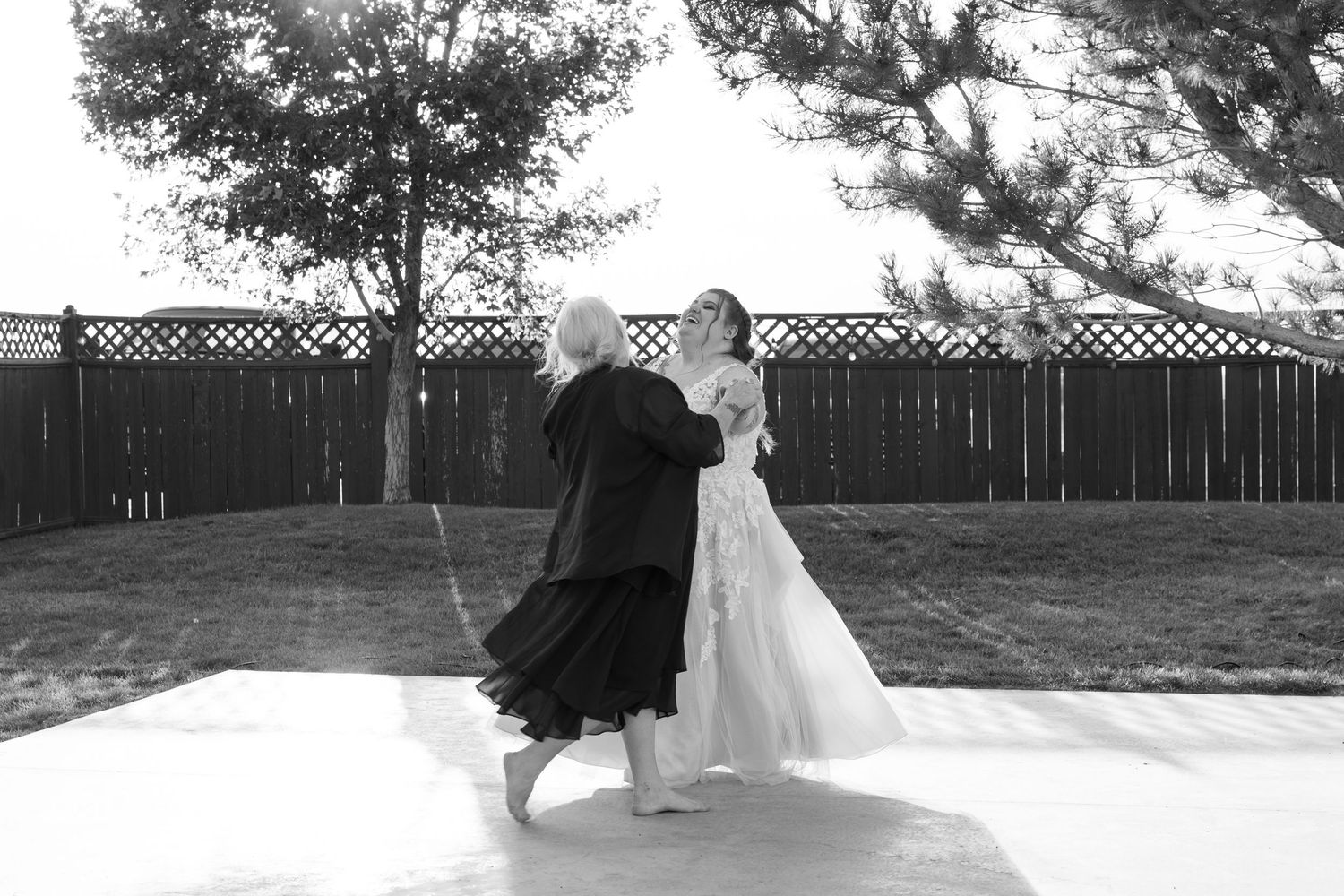 Black and white wedding photos showing outdoor dance moves and celebrations.