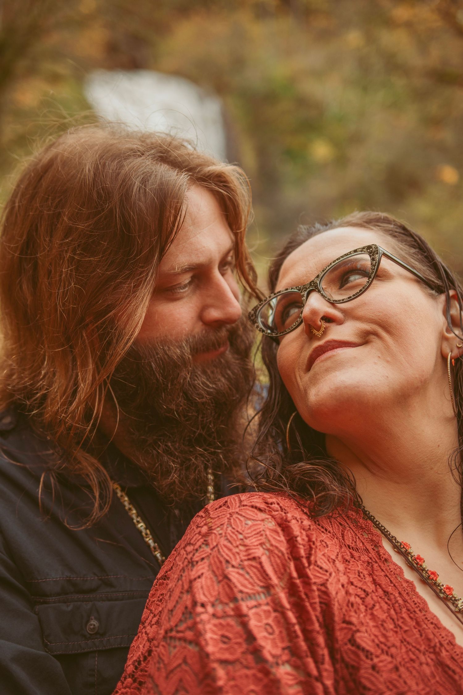 A romantic autumn photoshoot showing a couple in intimate poses.