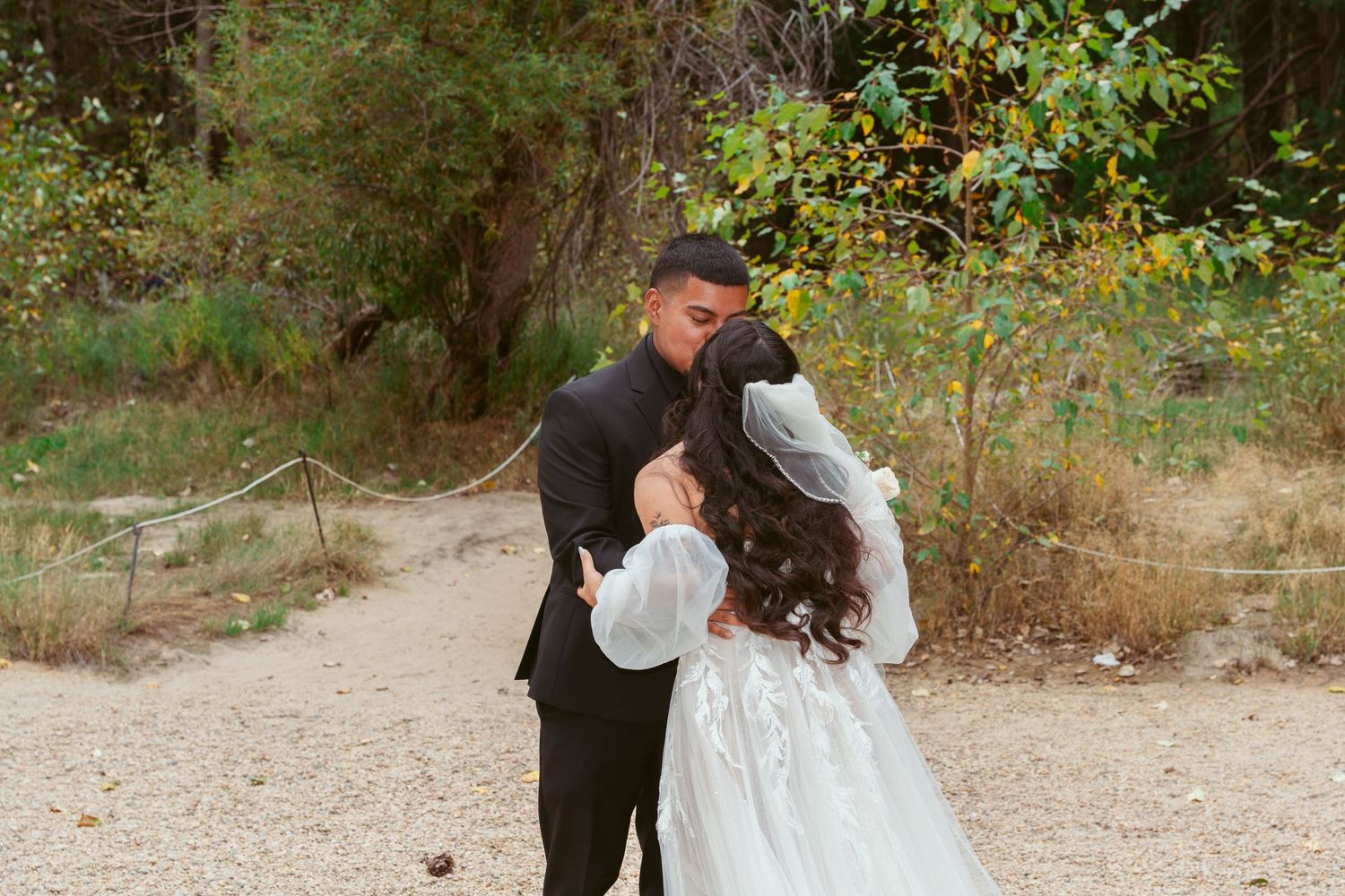Autumn wedding celebration with golden foliage and mountain backdrop.