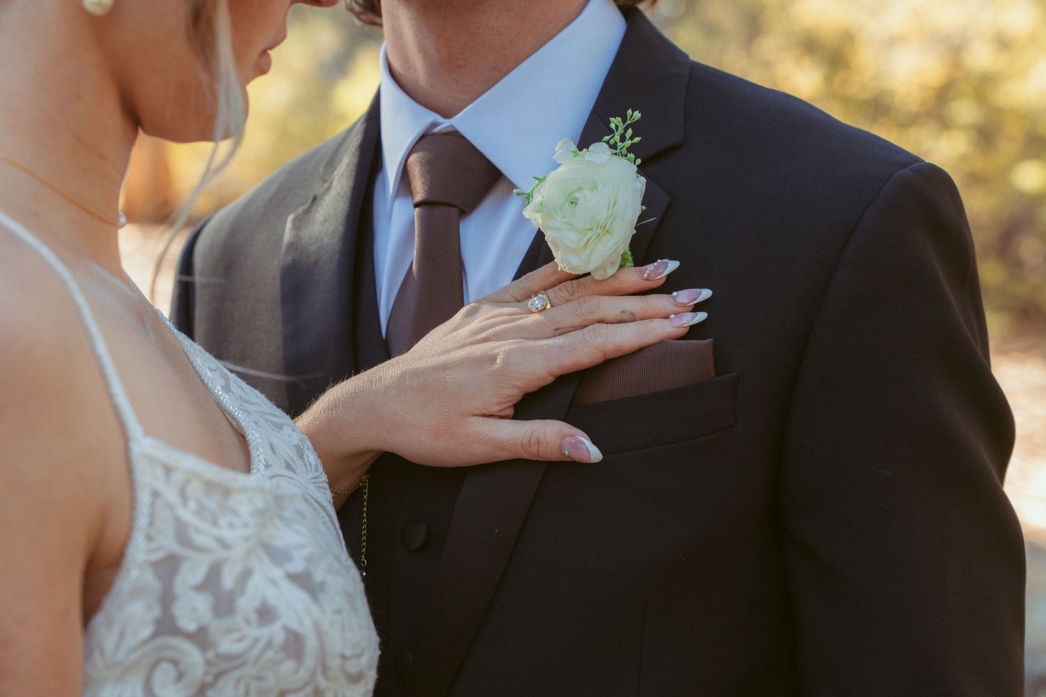 Elegant wedding portraits showing close-up details of bride and groom's attire.