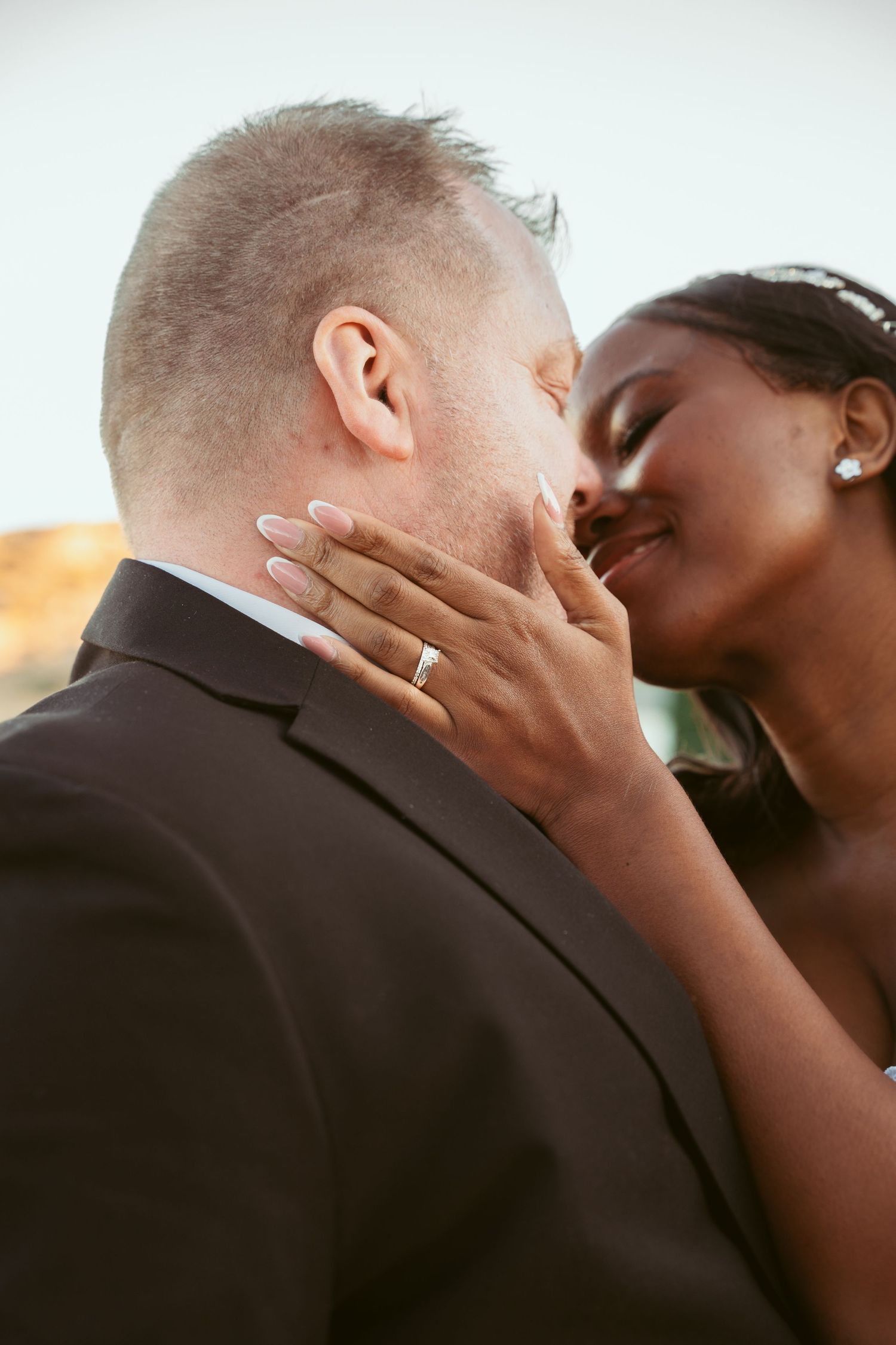Close-up shot of a tender wedding kiss between newlyweds.