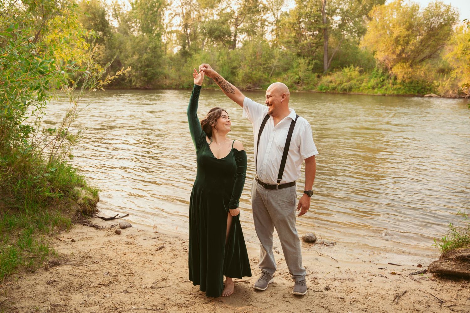 Couple enjoying a romantic moment by the riverside during an autumn photo session.