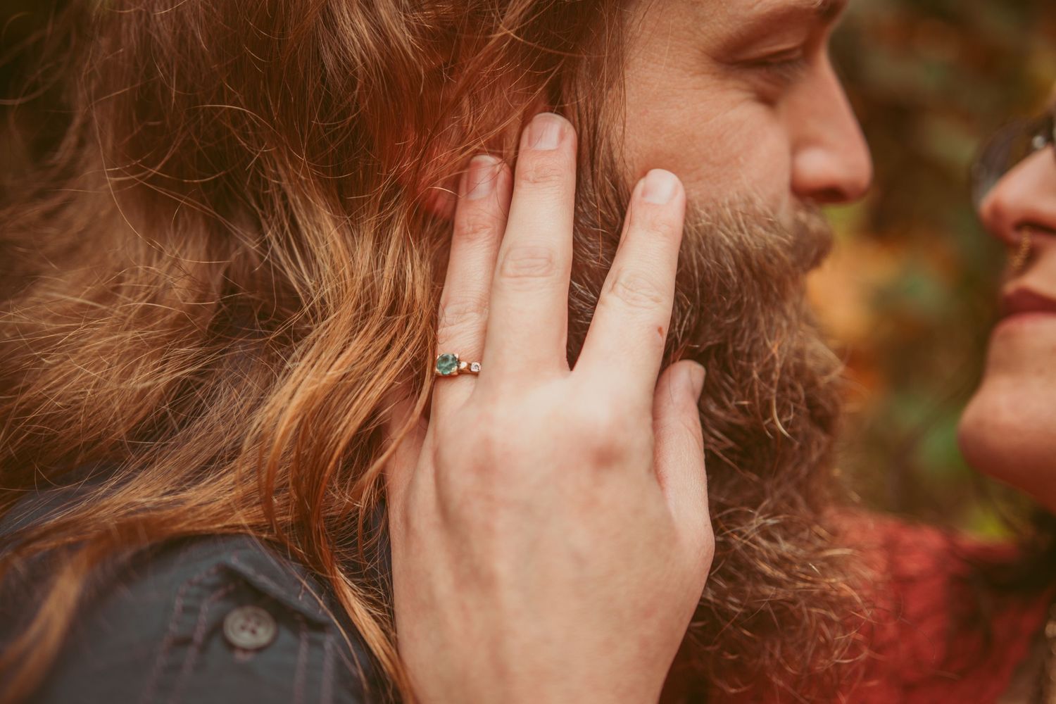 Close-up portrait showing intimate connection between two people in natural lighting.