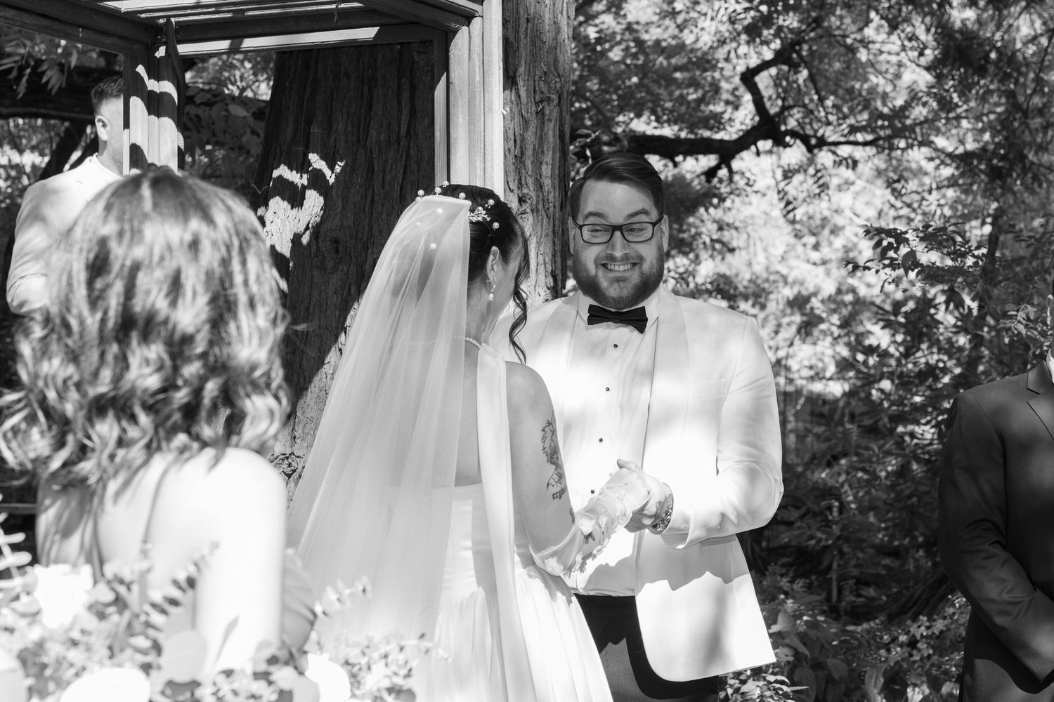 Black and white candid shots capture joyful moments at an outdoor wedding celebration.
