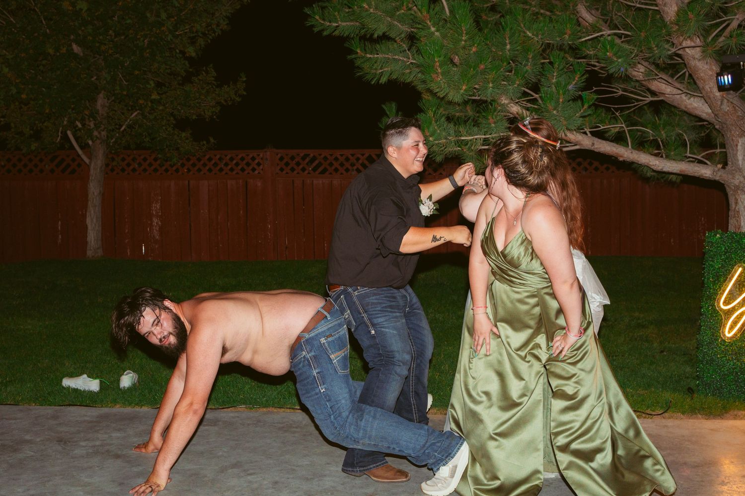 Wedding guests participate in lively outdoor dancing and celebrations at dusk.