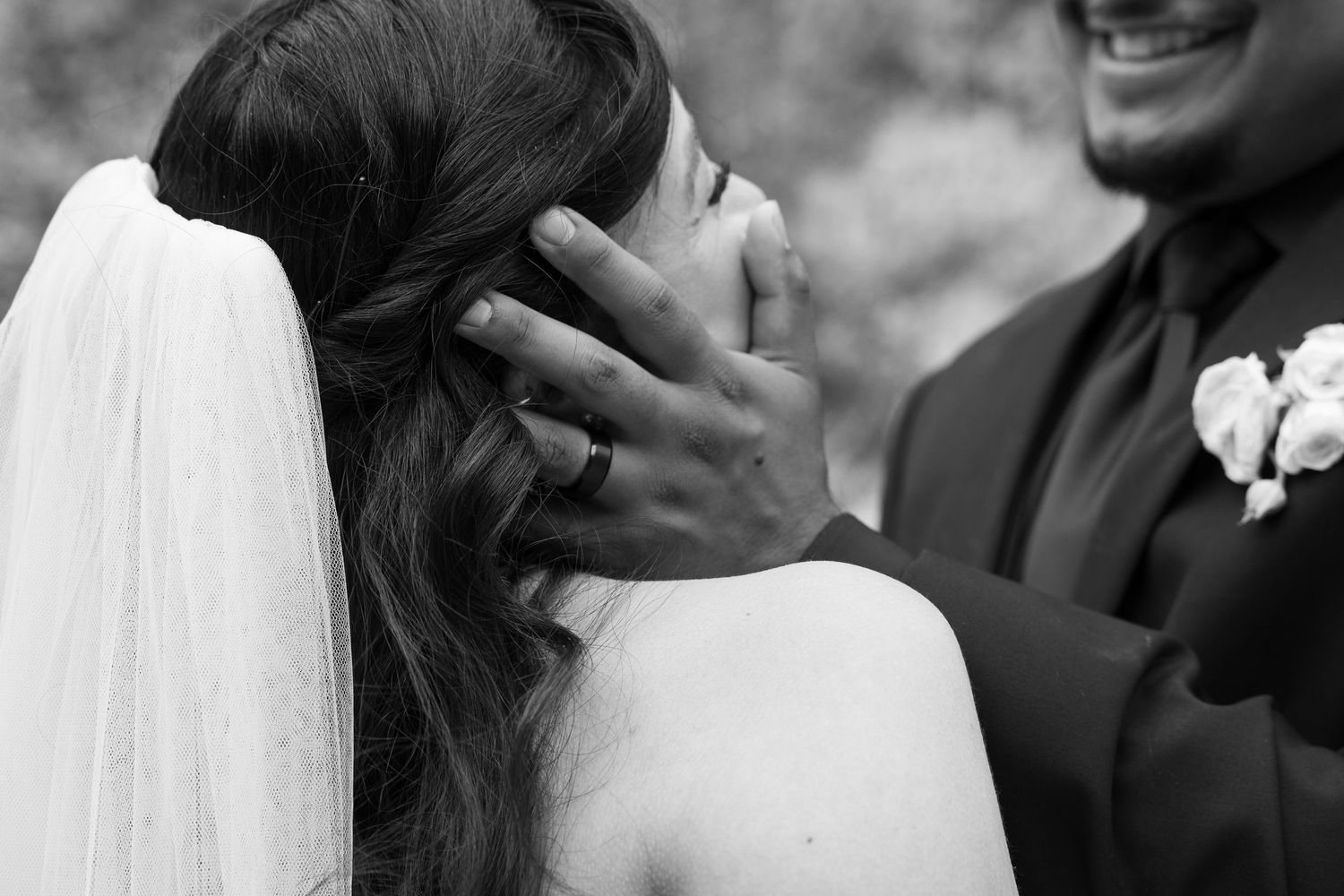 Intimate wedding moments captured in black and white showing tender embraces and joyful expressions.