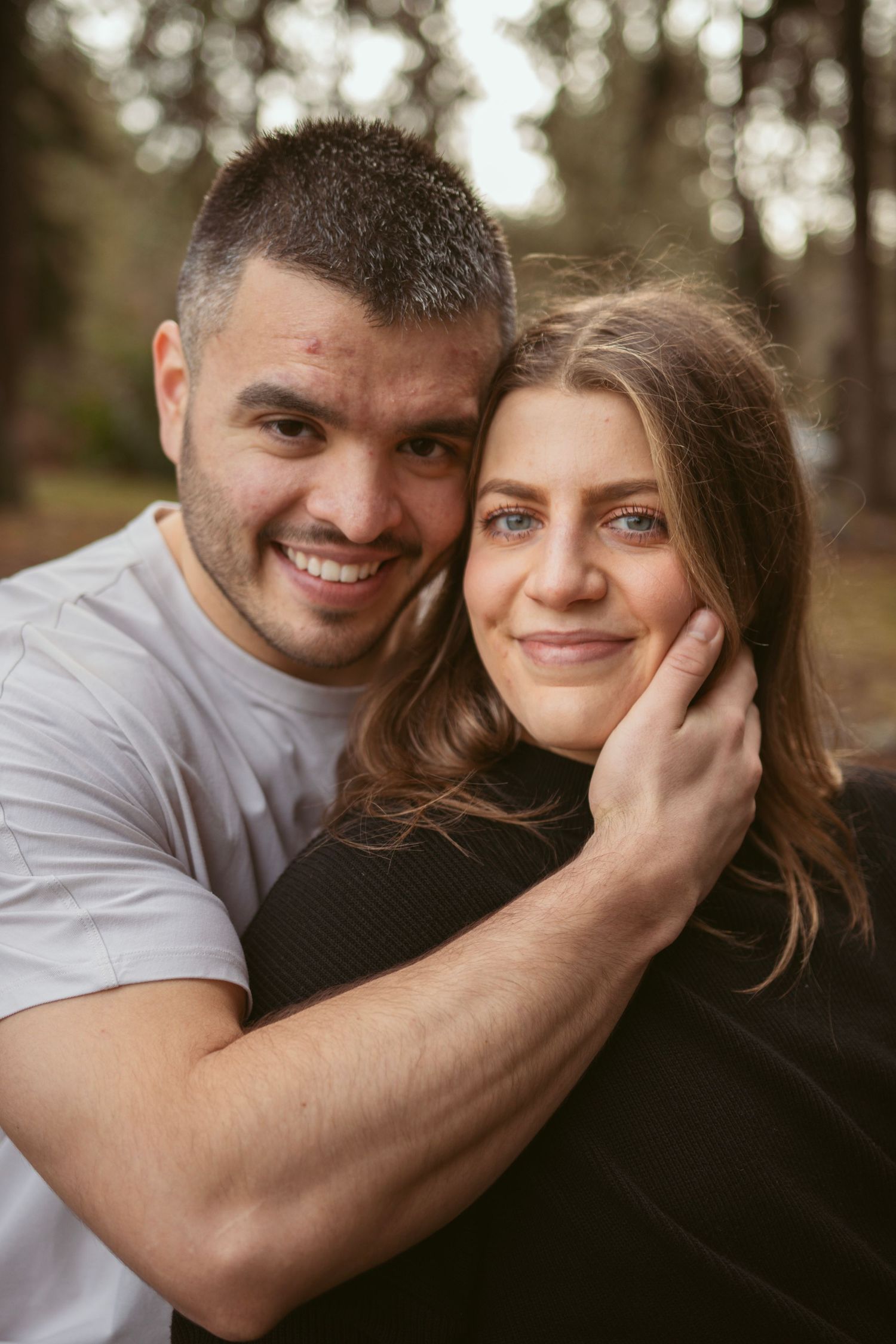 Intimate close-up portrait of couple sharing tender moments in natural lighting.