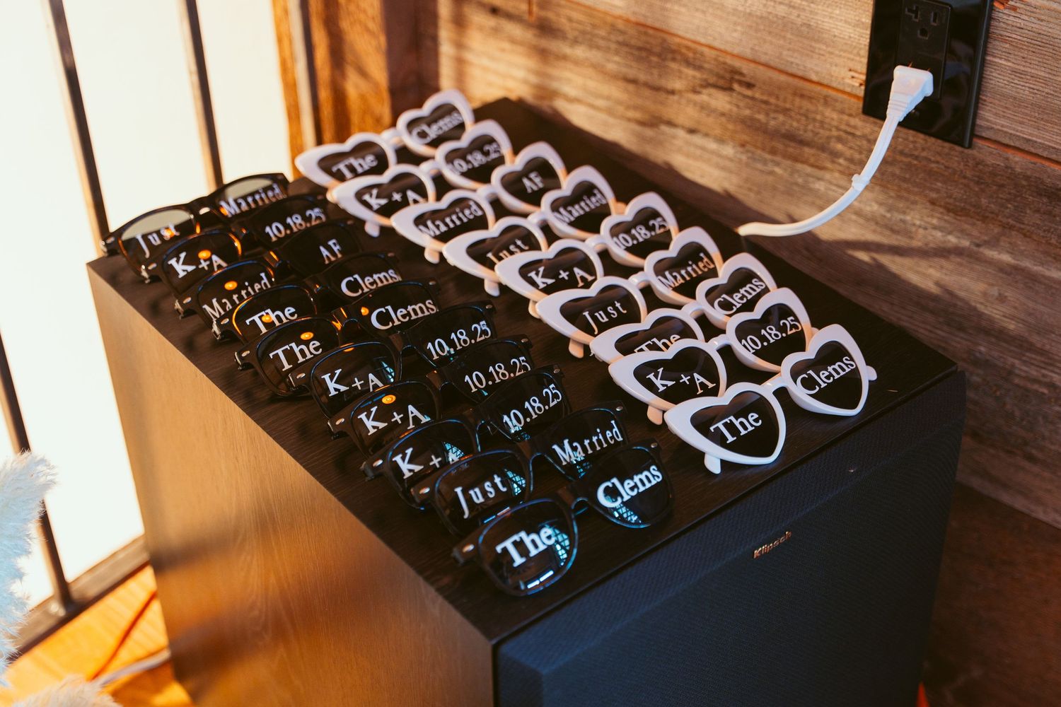 Wedding seating chart displayed on dark background with elegant script lettering.