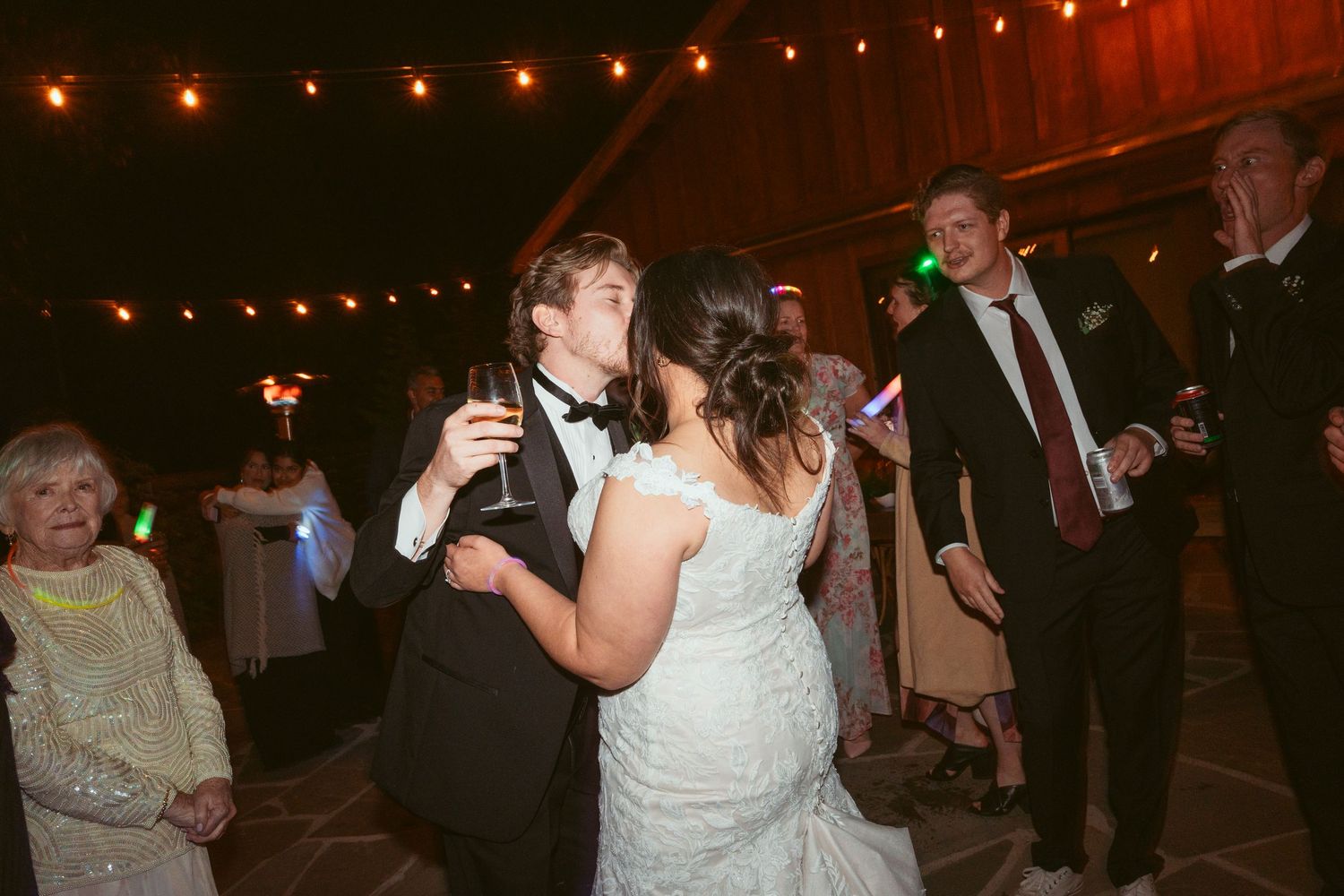 Wedding reception dance floor with string lights creating a warm ambiance overhead.