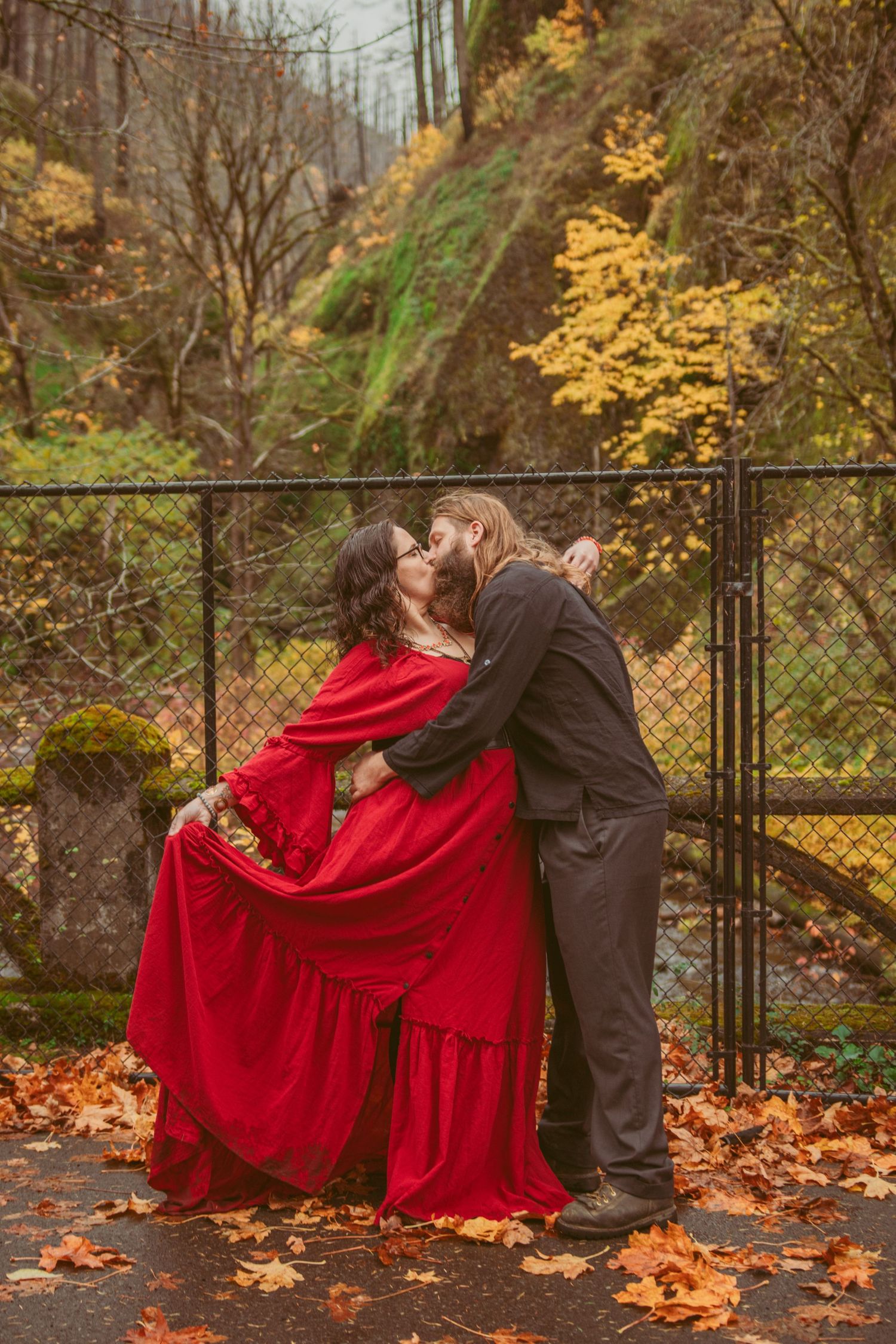 Romantic photo sequence with flowing red dress against autumn scenery and metal railing.