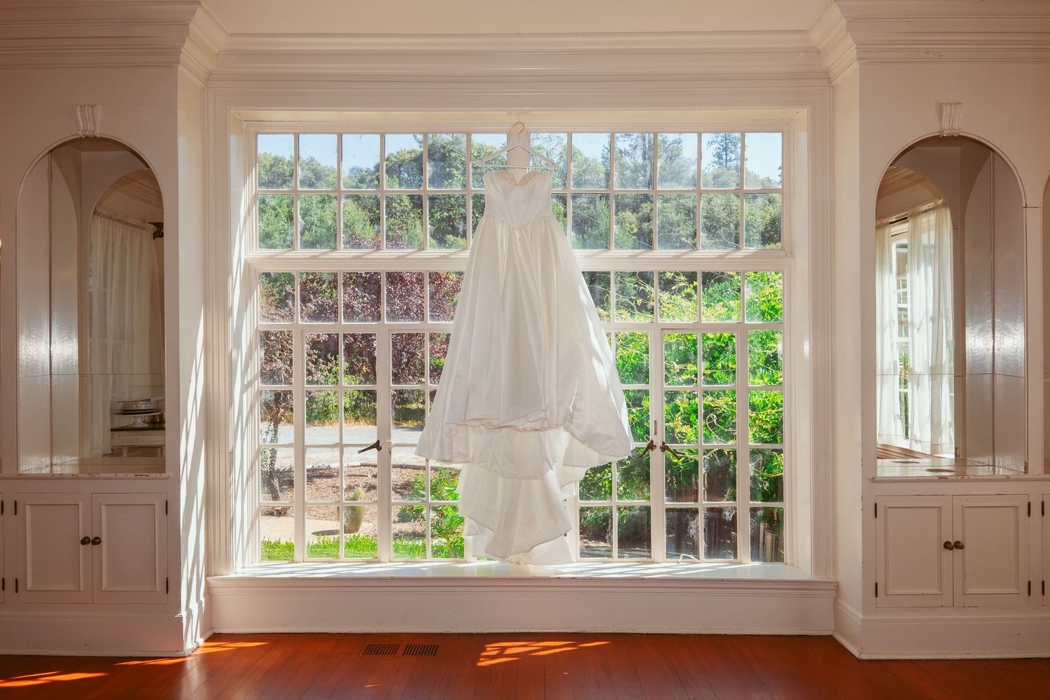 Large bright interior room with white walls and multiple windows letting in natural light.