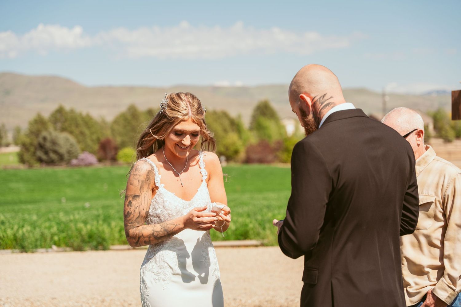 Emotional wedding ceremony exchange between couple in scenic outdoor setting.