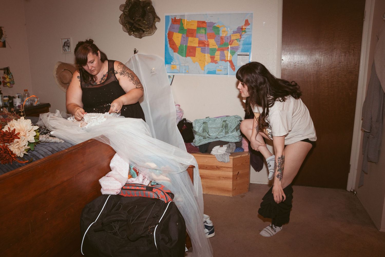 A room with US maps on the wall and people gathered in casual setting.