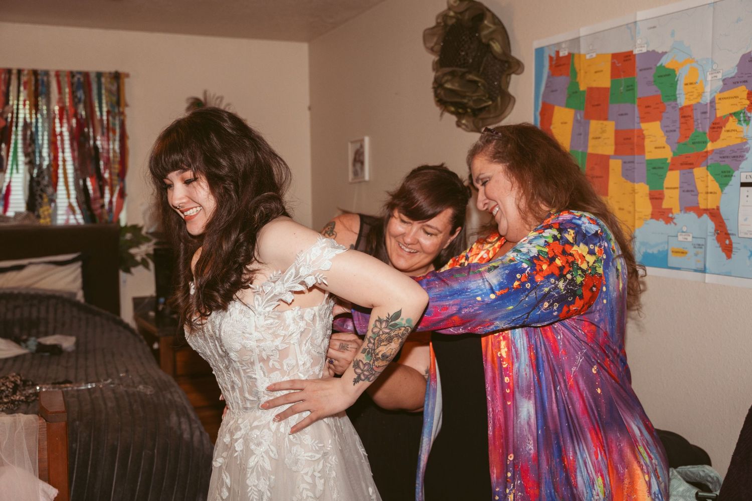People dancing and celebrating in a room with colorful decorations and a map on the wall.