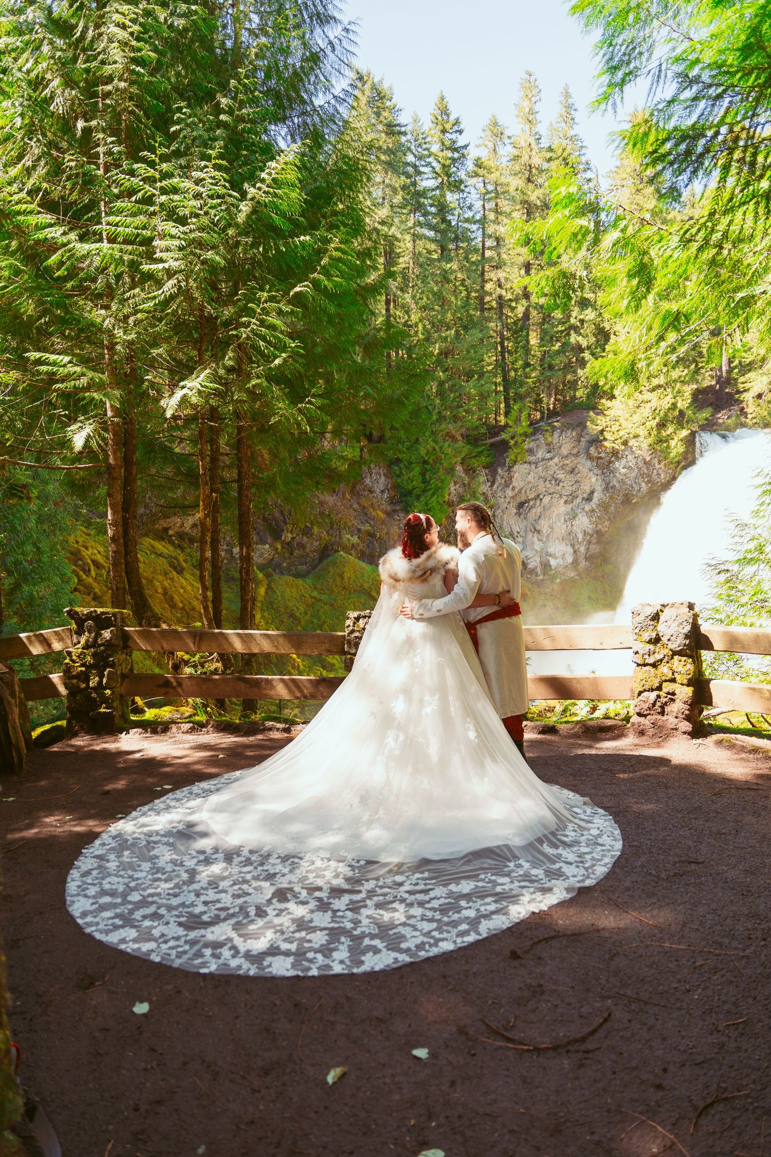 A dramatic white wedding dress with long train photographed in sequence against forest ground.