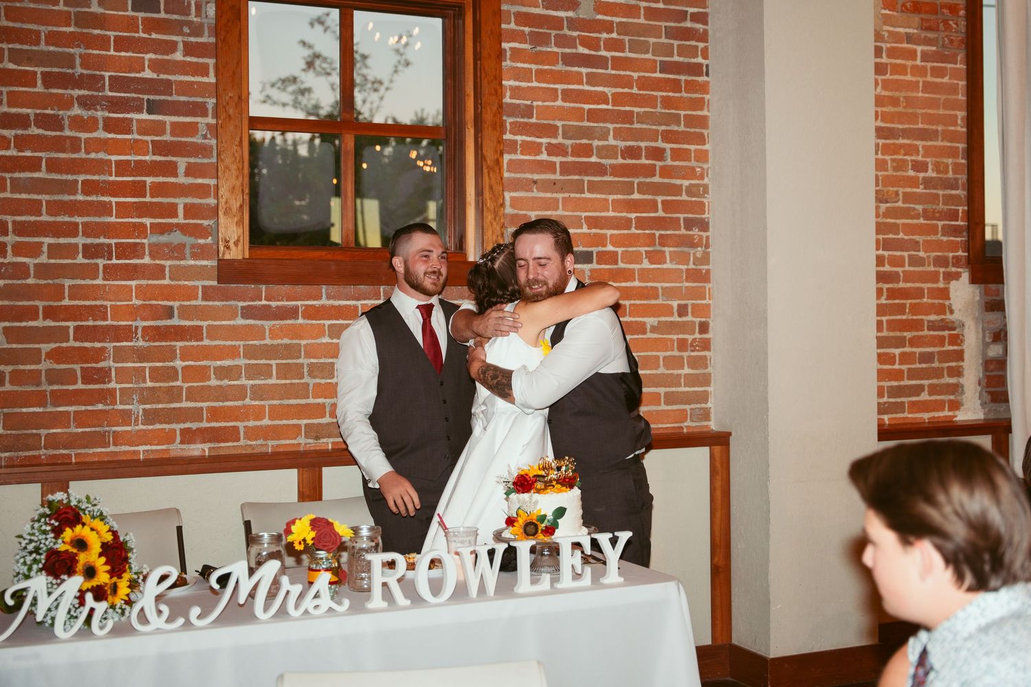 Wedding celebration space with exposed brick architecture and custom name display.