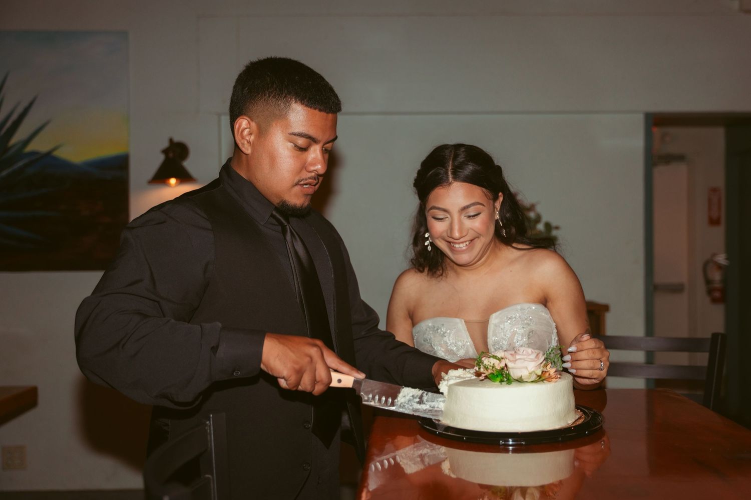 Reception sequence showing newlyweds sharing their first cake cutting moments together.