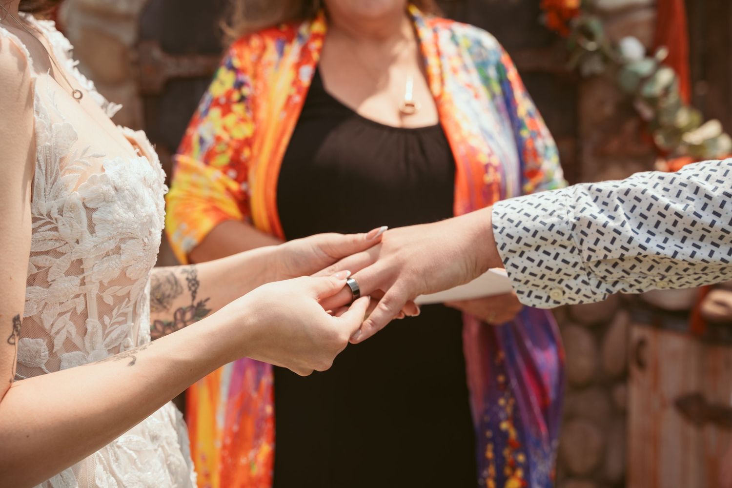 Close-up of hands joining together in a circle during a celebration.