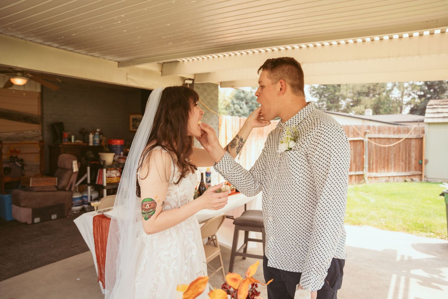 A couple dancing together on a covered outdoor patio during a celebration.