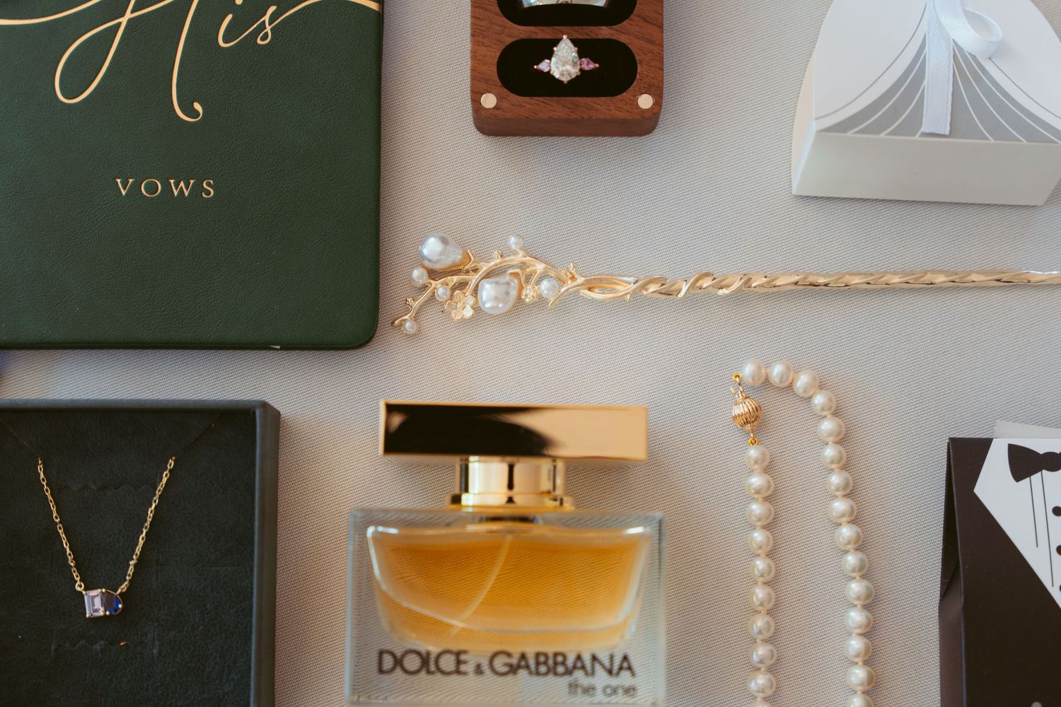 Wedding reception details showcase elegant decor with pearls, gold accents, and luxury brand elements.