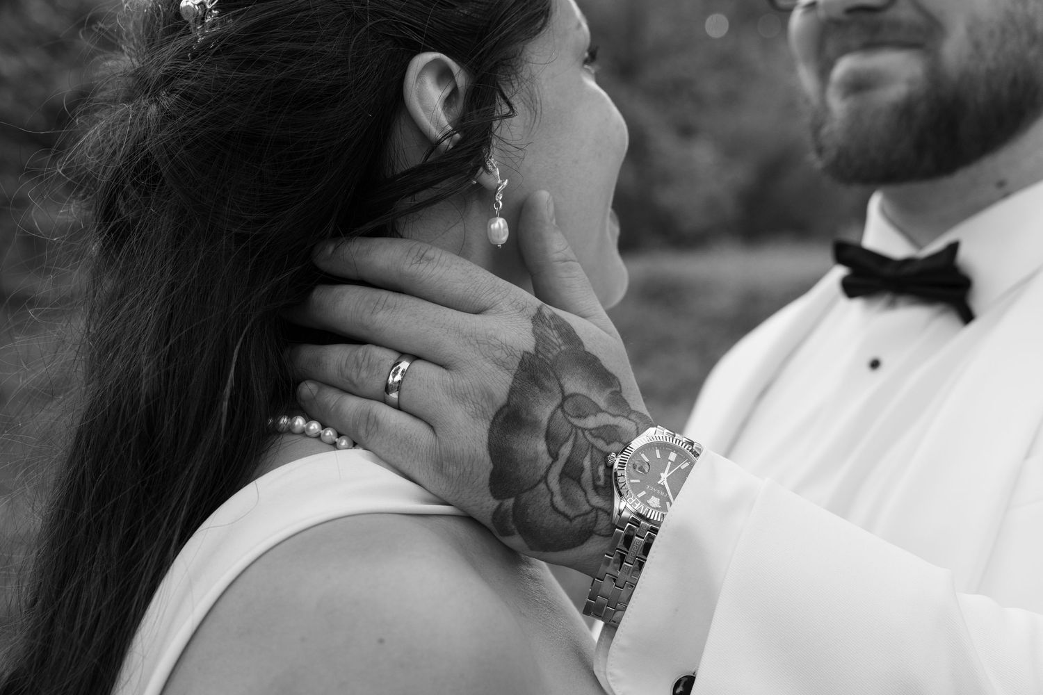 A romantic black and white wedding photo series showing intimate close-up moments between the bride and groom.