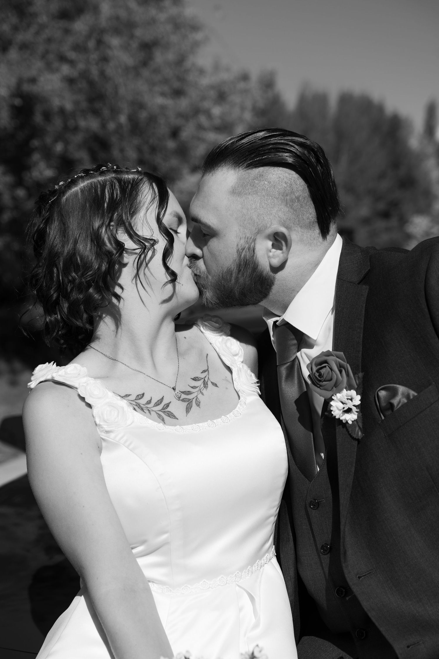 Black and white romantic wedding portrait showing tender moment between couple.