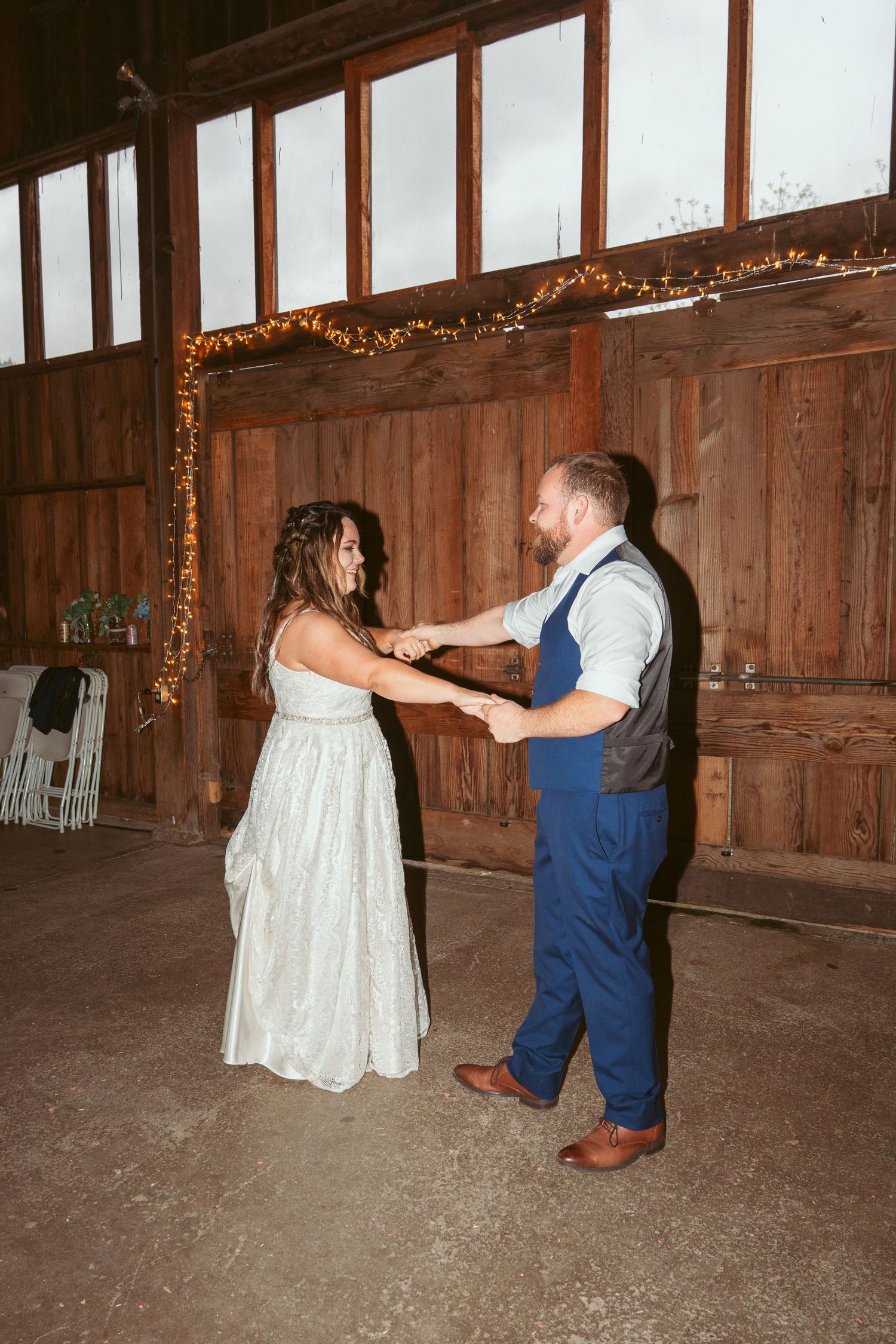 Dancing partners twirl and spin across a barn floor during a celebration.