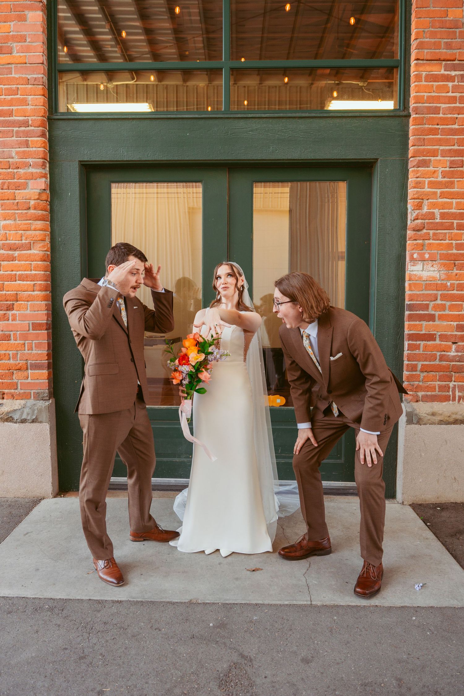 Fun wedding party photo sequence shows groomsmen falling down dramatically against brick wall.