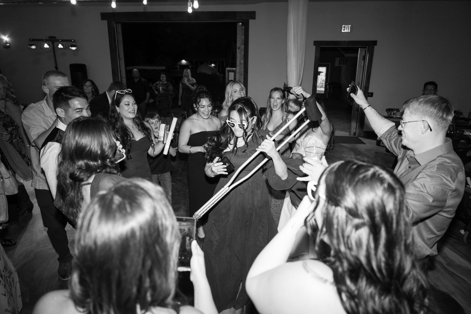 Black and white photo of wedding reception dance party in full swing.