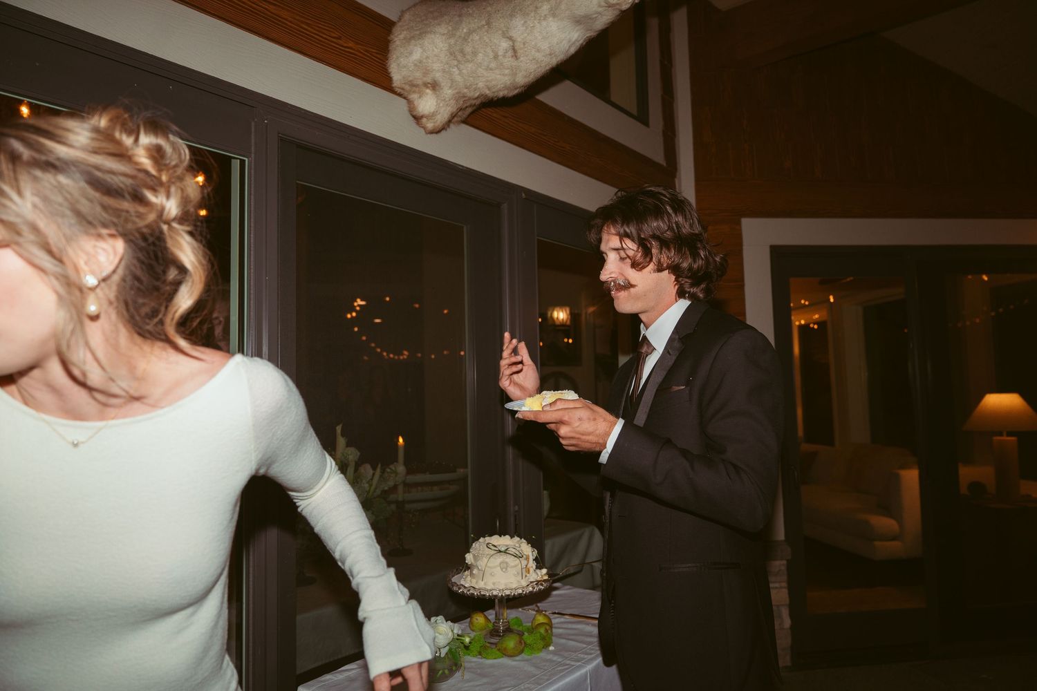 A couple participates in the traditional cake feeding ritual at their wedding reception.