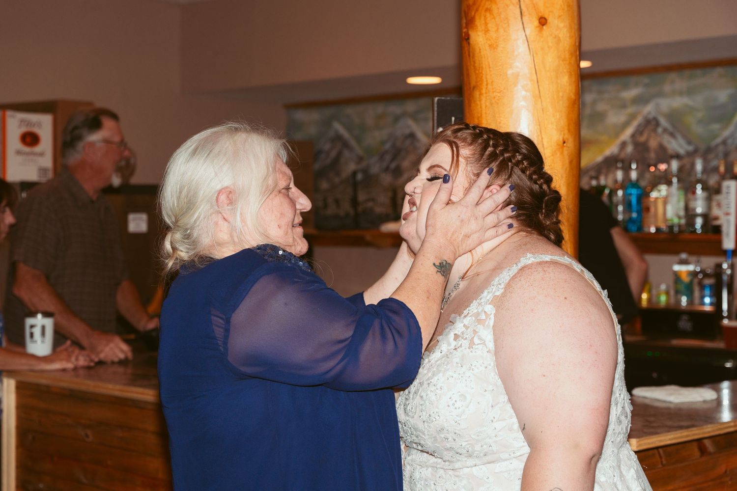 Wedding guests celebrate and dance together at a joyous indoor reception party.