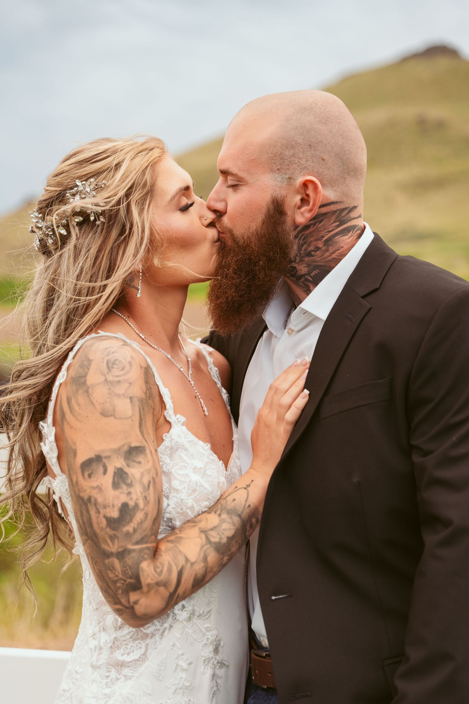Romantic wedding moment captured against mountain backdrop.