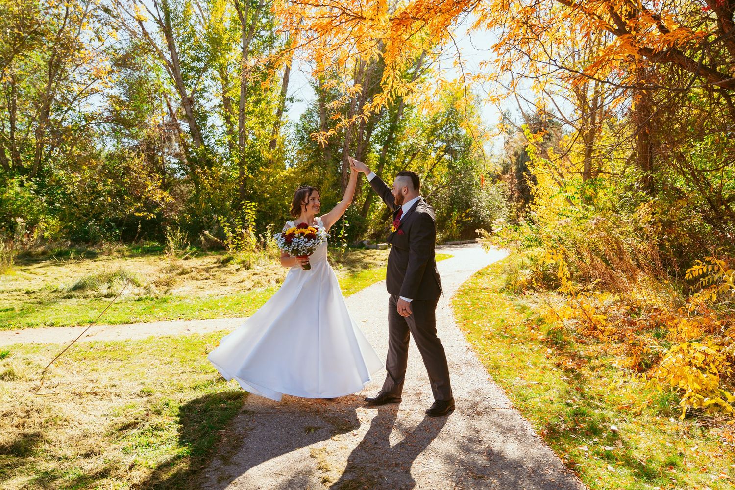 A romantic dance sequence captured on a sunlit autumn path.