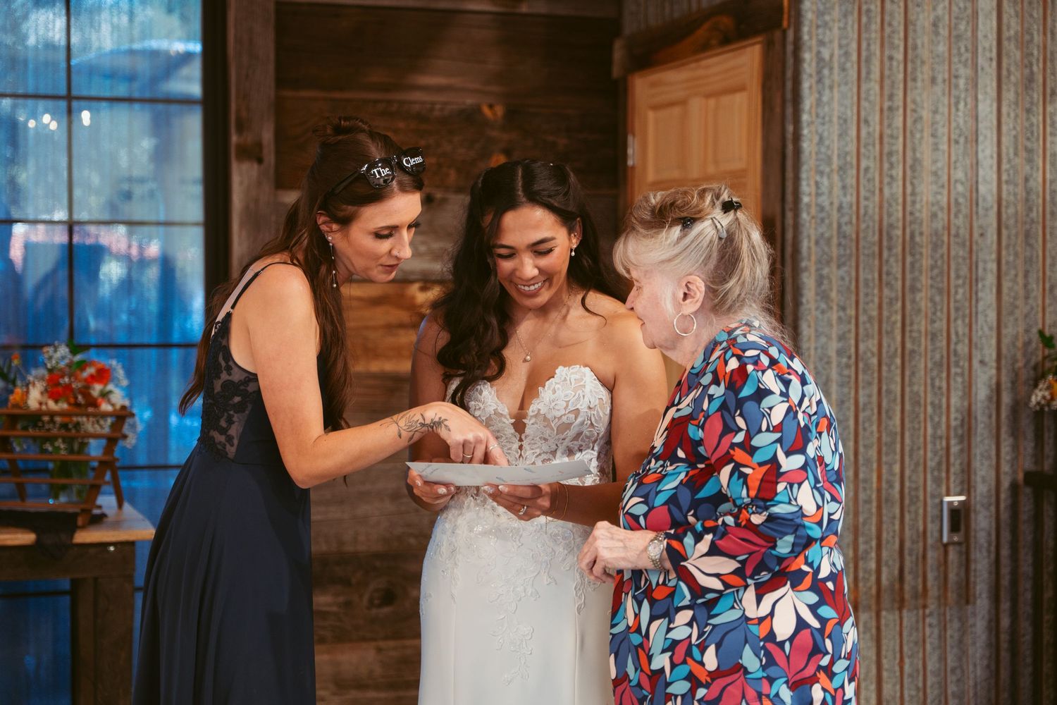 Wedding reception scene showing cake cutting tradition with decorative floral arrangements.