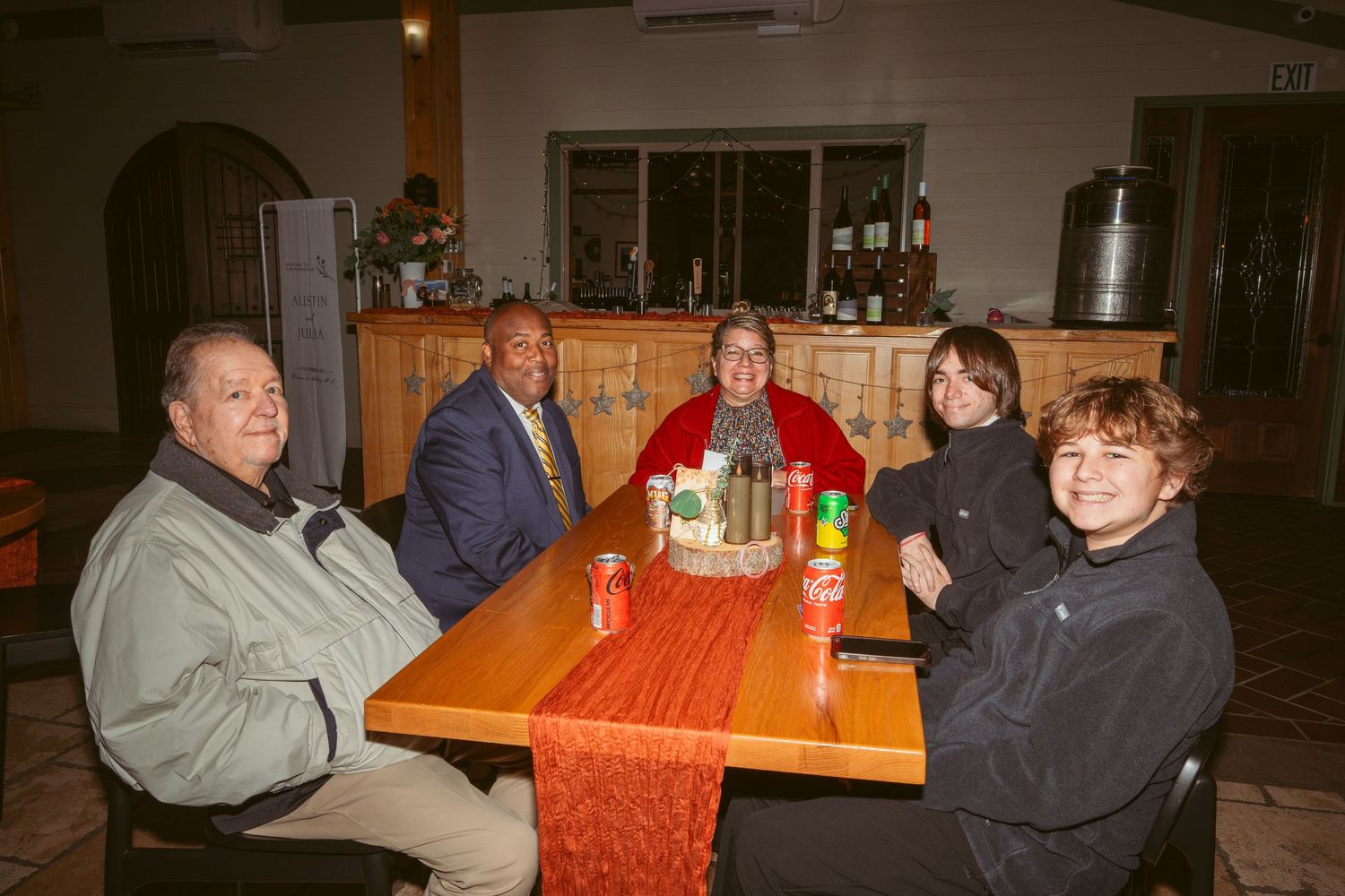 Friends and family gathered at tables for a casual evening meal.