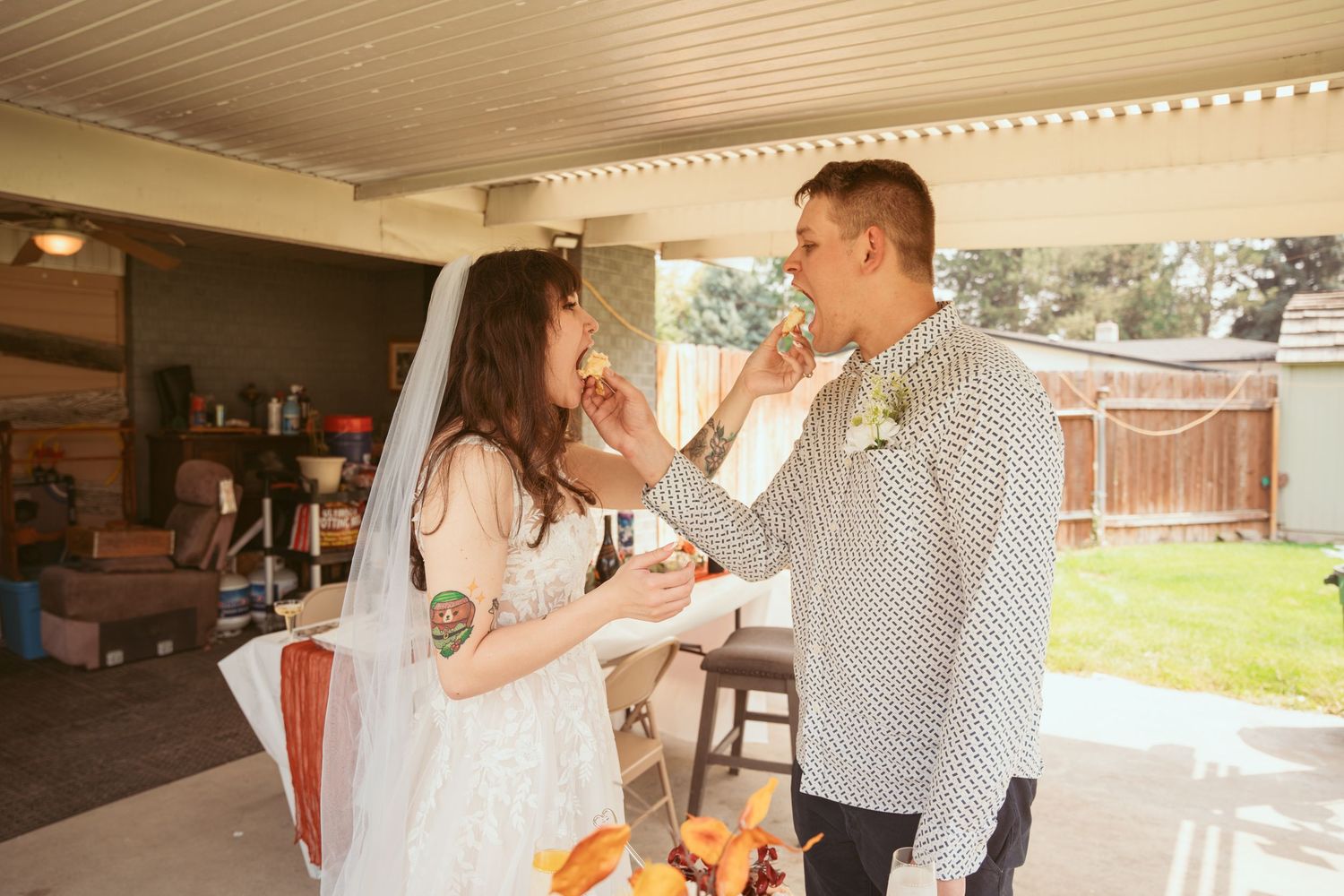 A couple shares tender moments during their wedding reception under wooden ceiling panels.