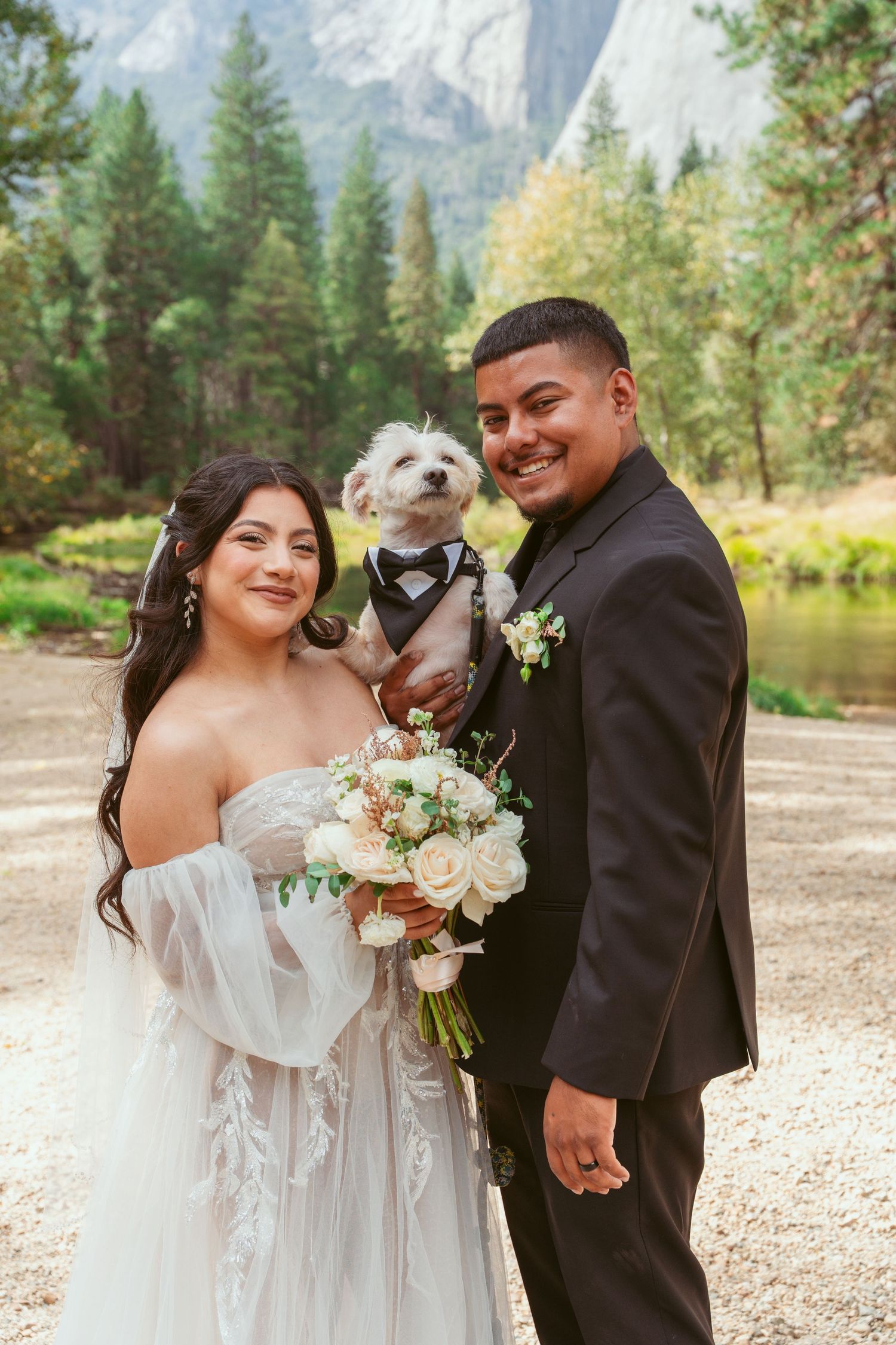 Wedding party with small white dog posing in Yosemite National Park.
