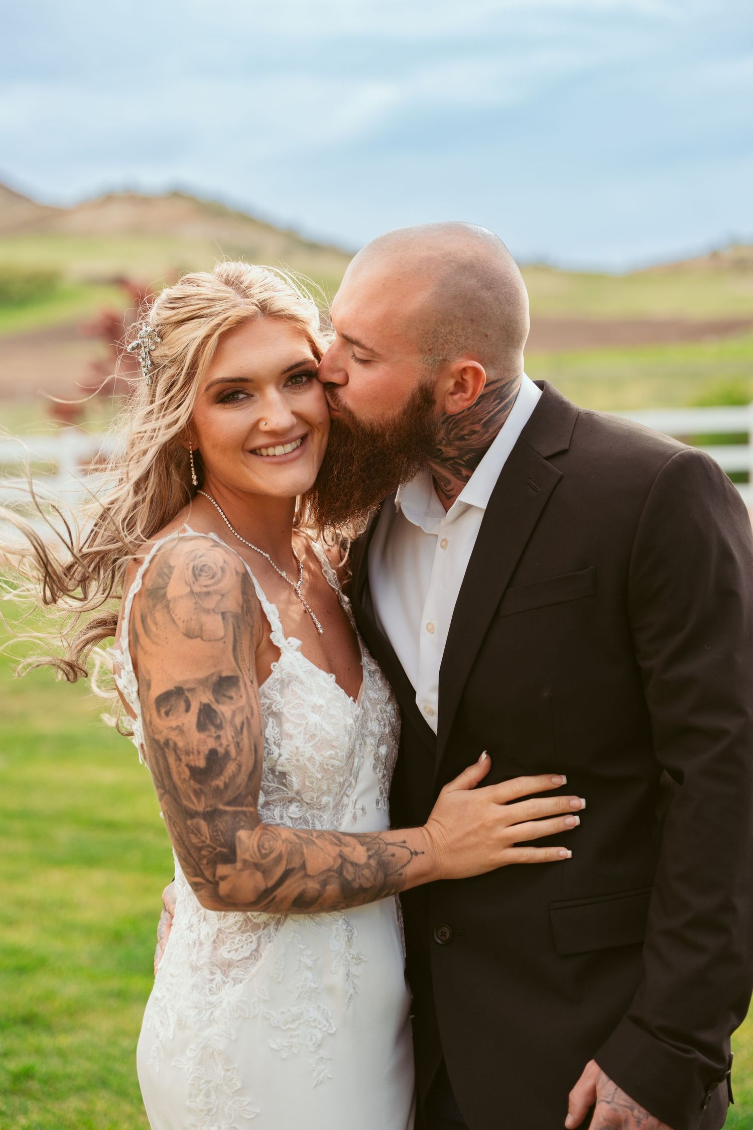 Candid wedding portraits in scenic mountain landscape with natural lighting.