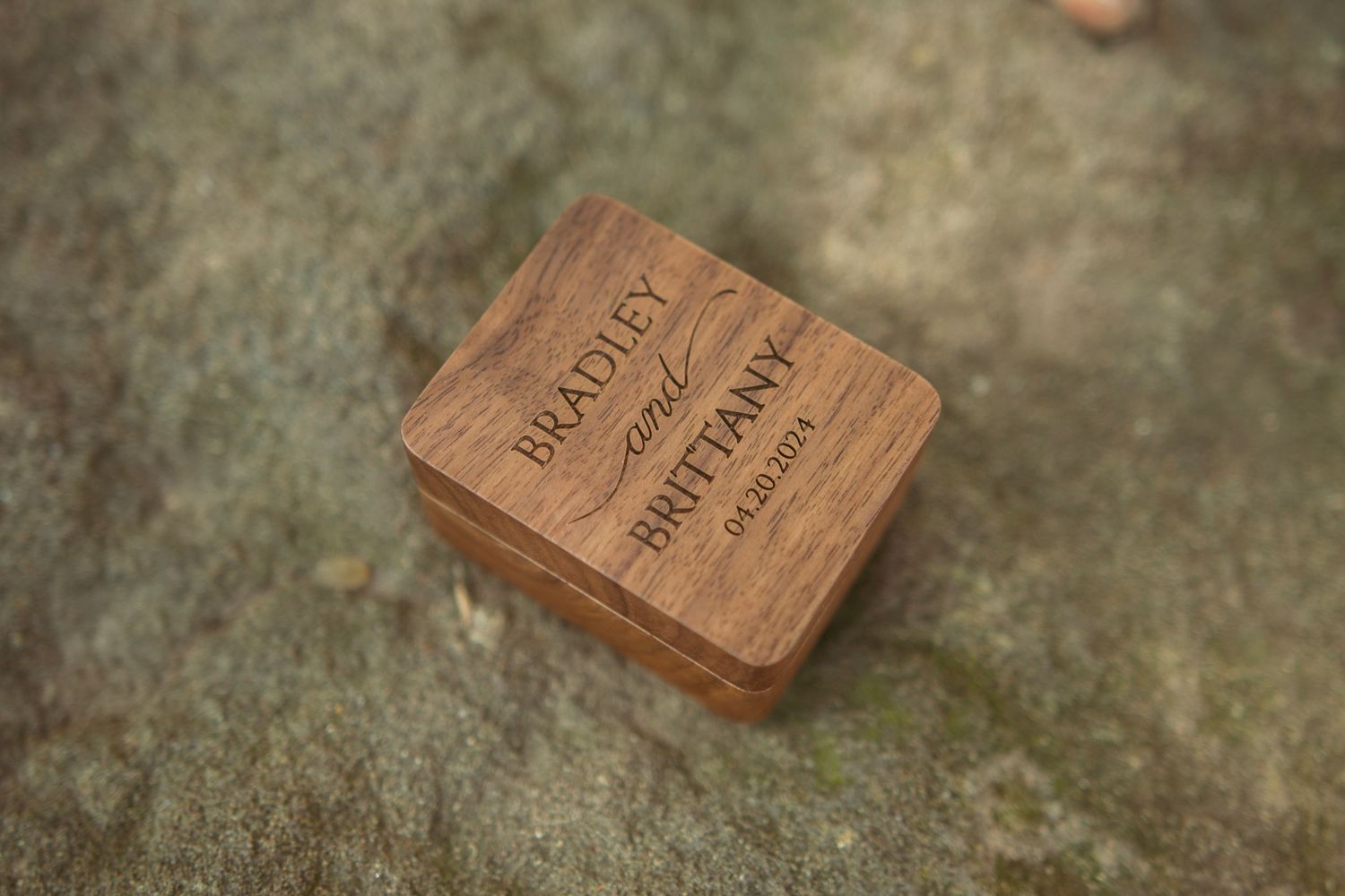 Rustic wooden decor elements arranged on weathered stone surface.