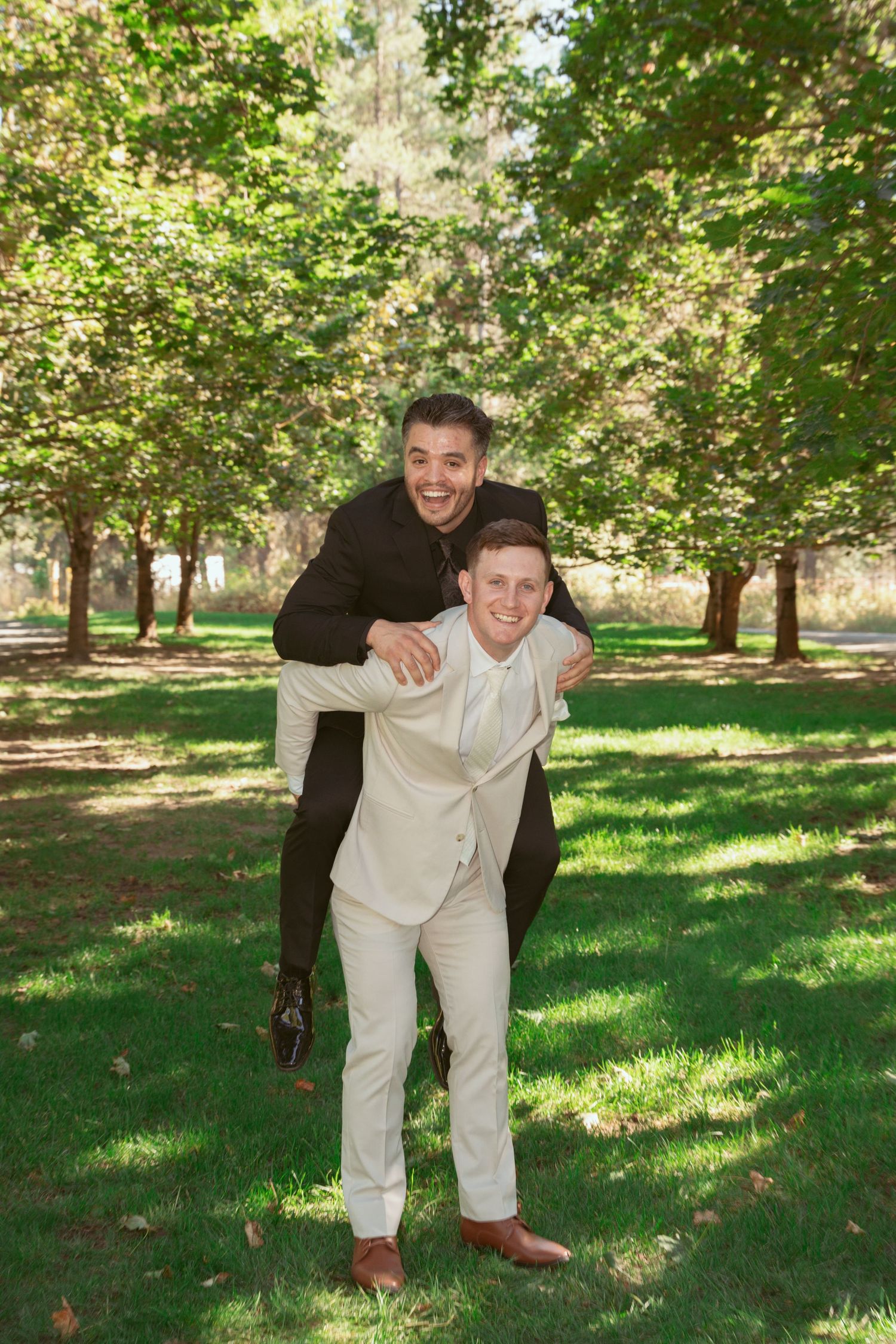 Playful groomsmen portraits showing casual poses in a park setting.