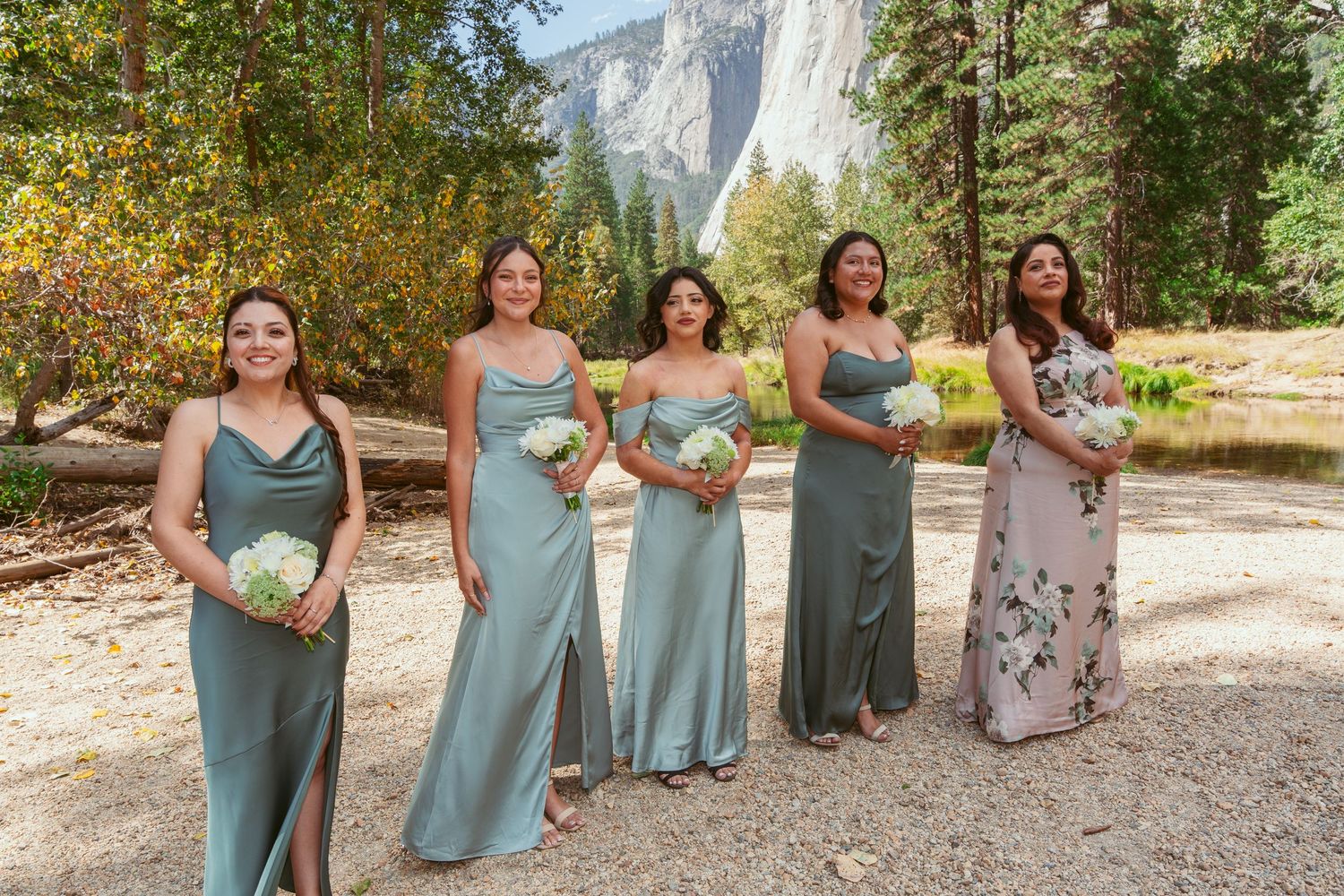 Bridesmaids in blue dresses posing together at outdoor Yosemite wedding venue.