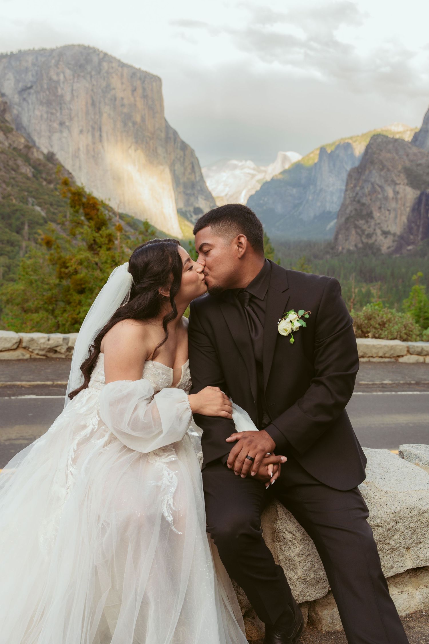 Romantic wedding couple sharing tender moments with Yosemite's dramatic landscape as their backdrop.