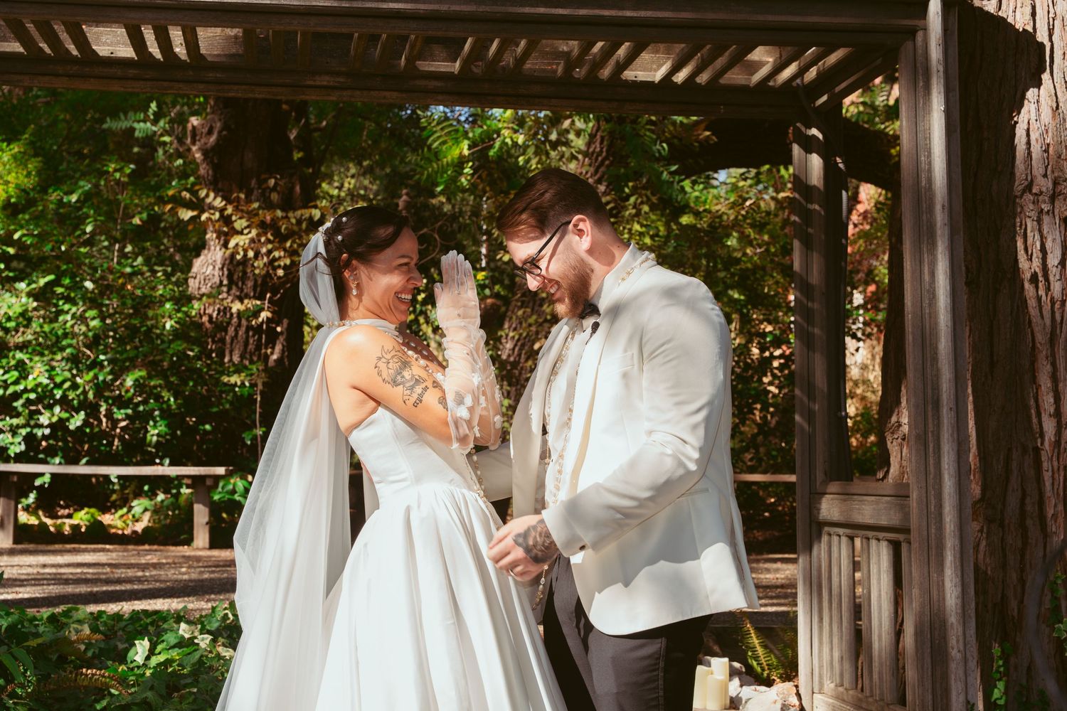 Intimate wedding ceremony moment captured beneath wooden beams with natural lighting.