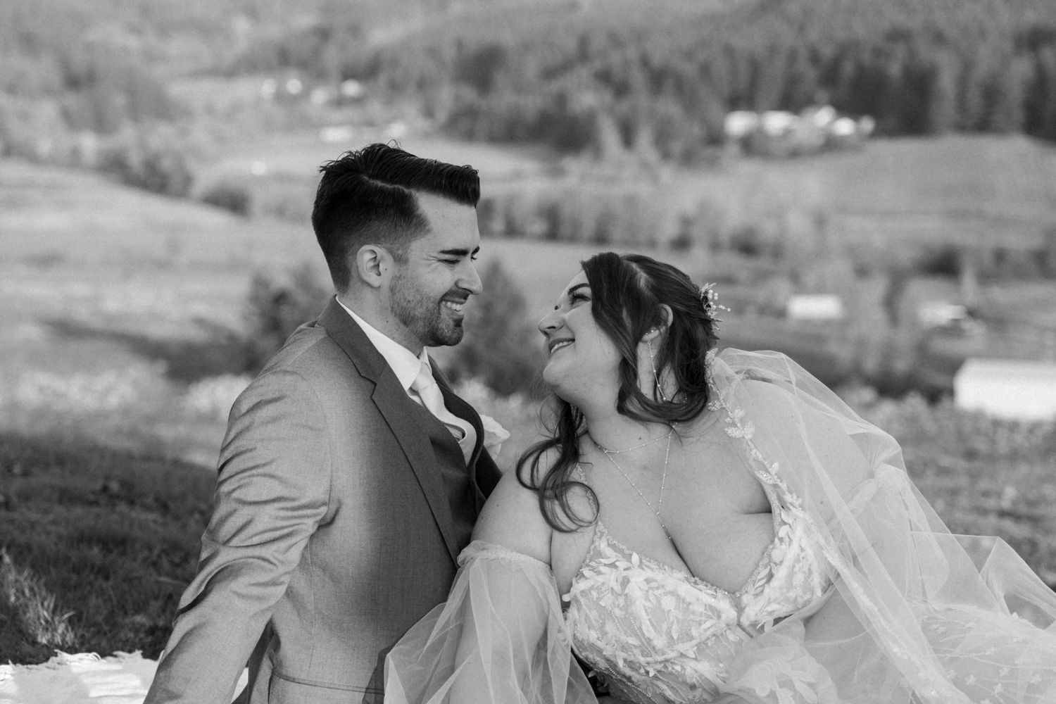 Romantic wedding portrait with rolling hills and autumn foliage in background.