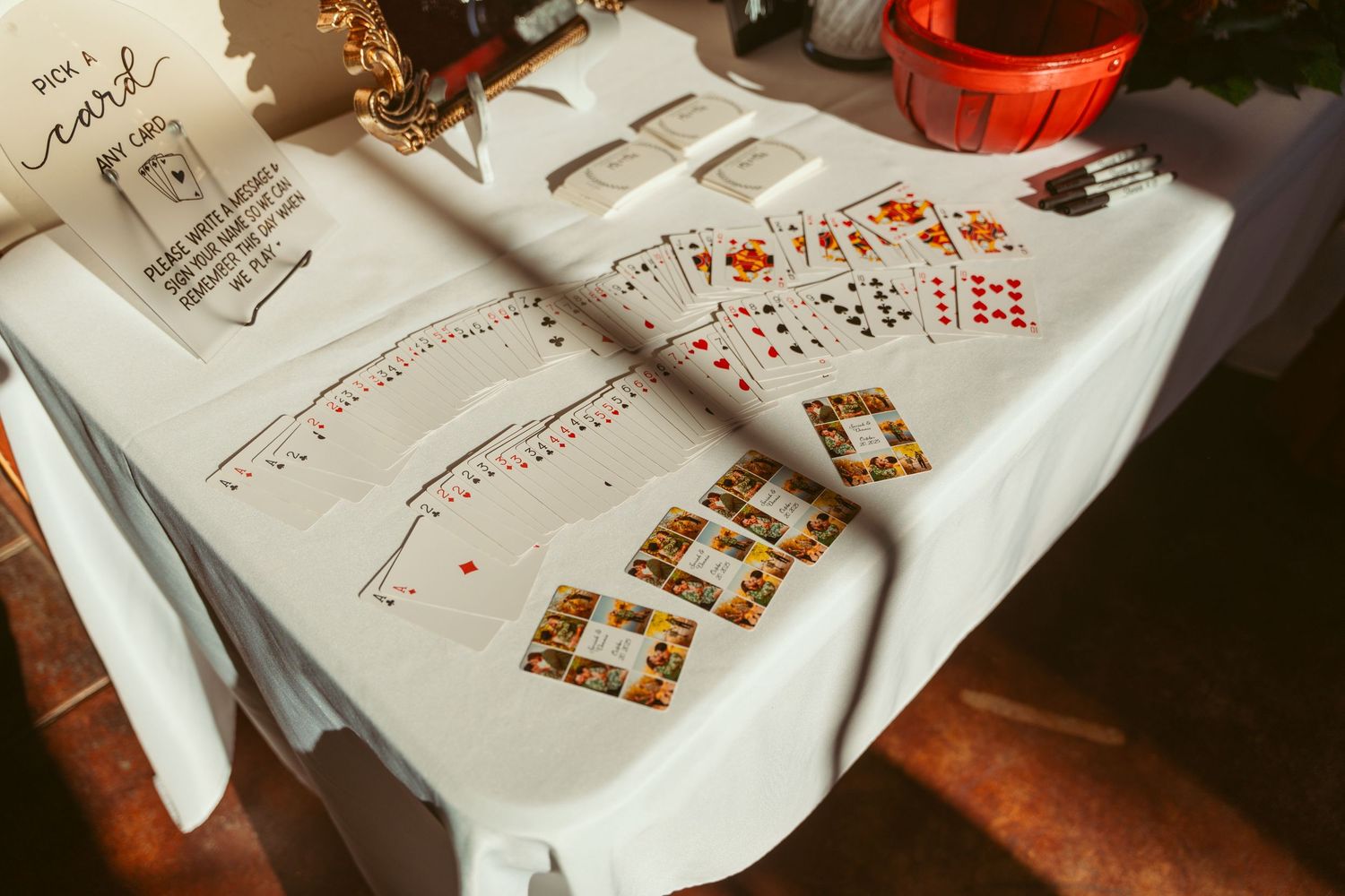 Wedding reception table setup with playing cards and decorative elements.