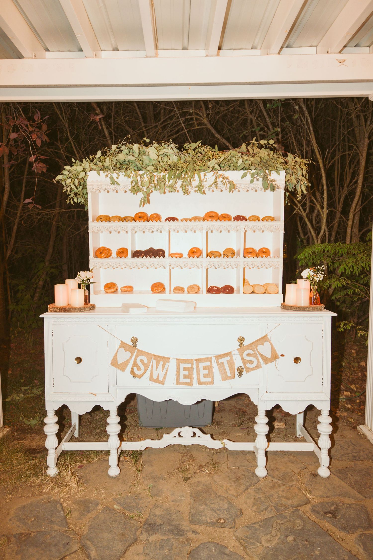White decorative table display with pumpkin artwork and 'Sweets' sign at a wedding reception.