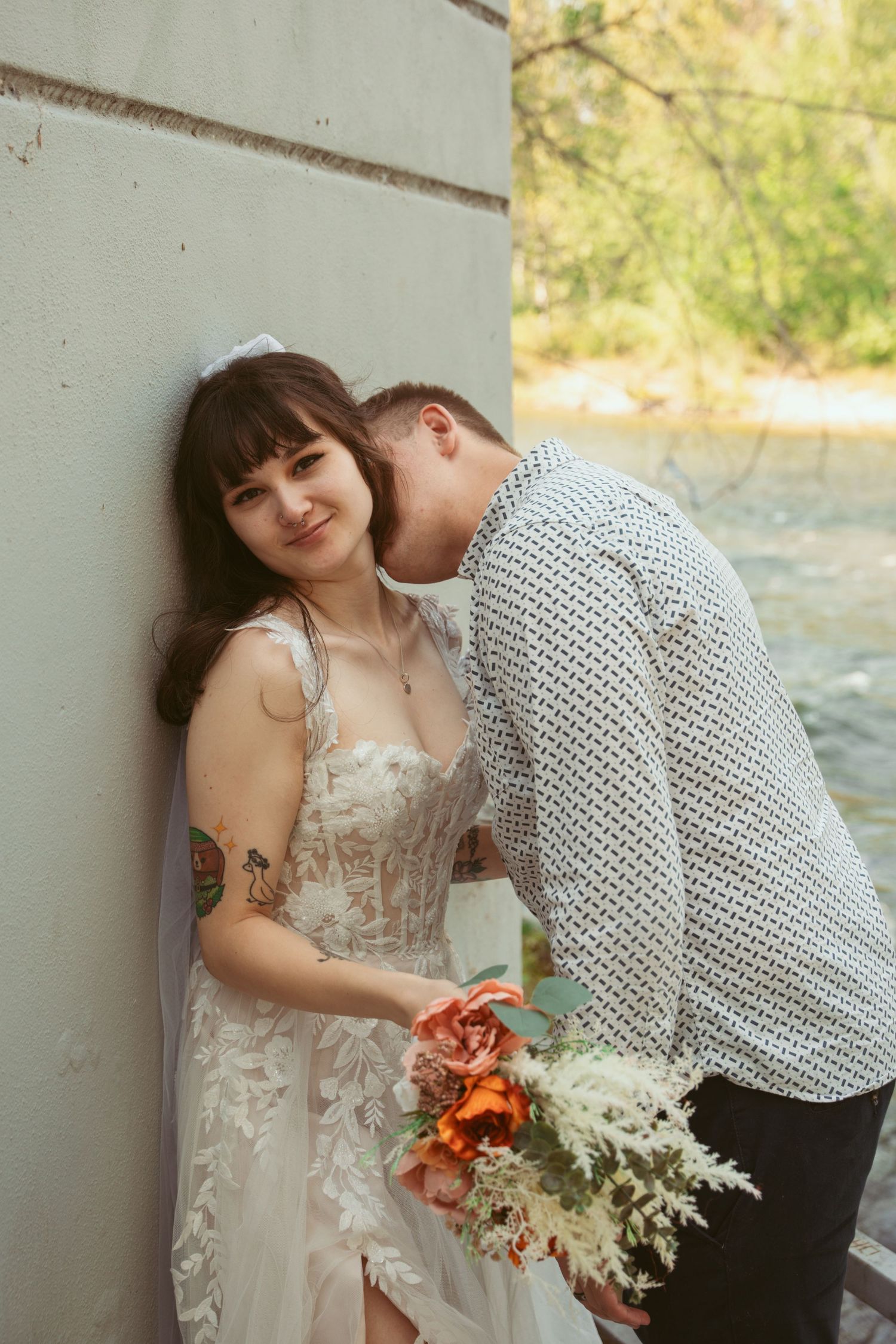 An intimate wedding portrait sequence showing tender moments between a couple against a light wall.